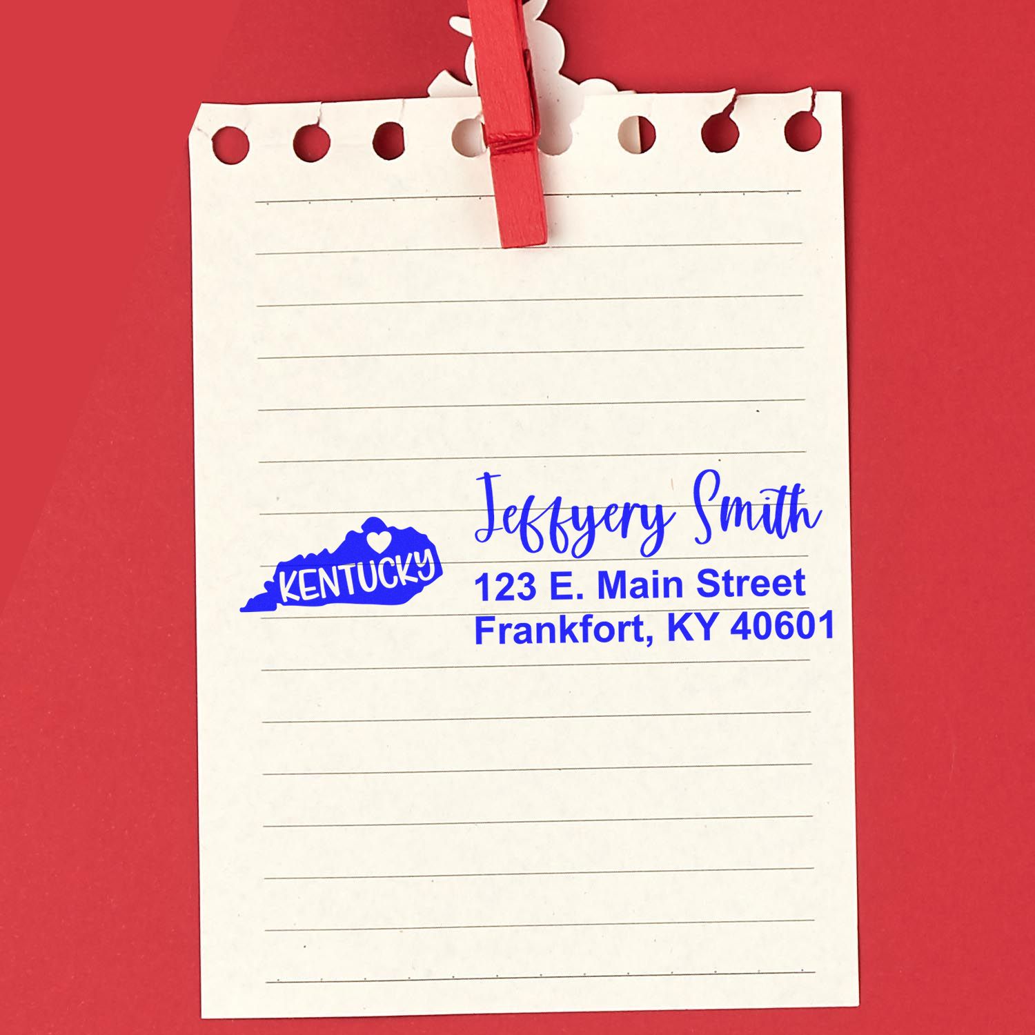 State Love of Kentucky Custom Address Stamp Self-Inking on notepad, featuring a blue Kentucky state outline with heart, personalized with name and address in blue ink on red background.