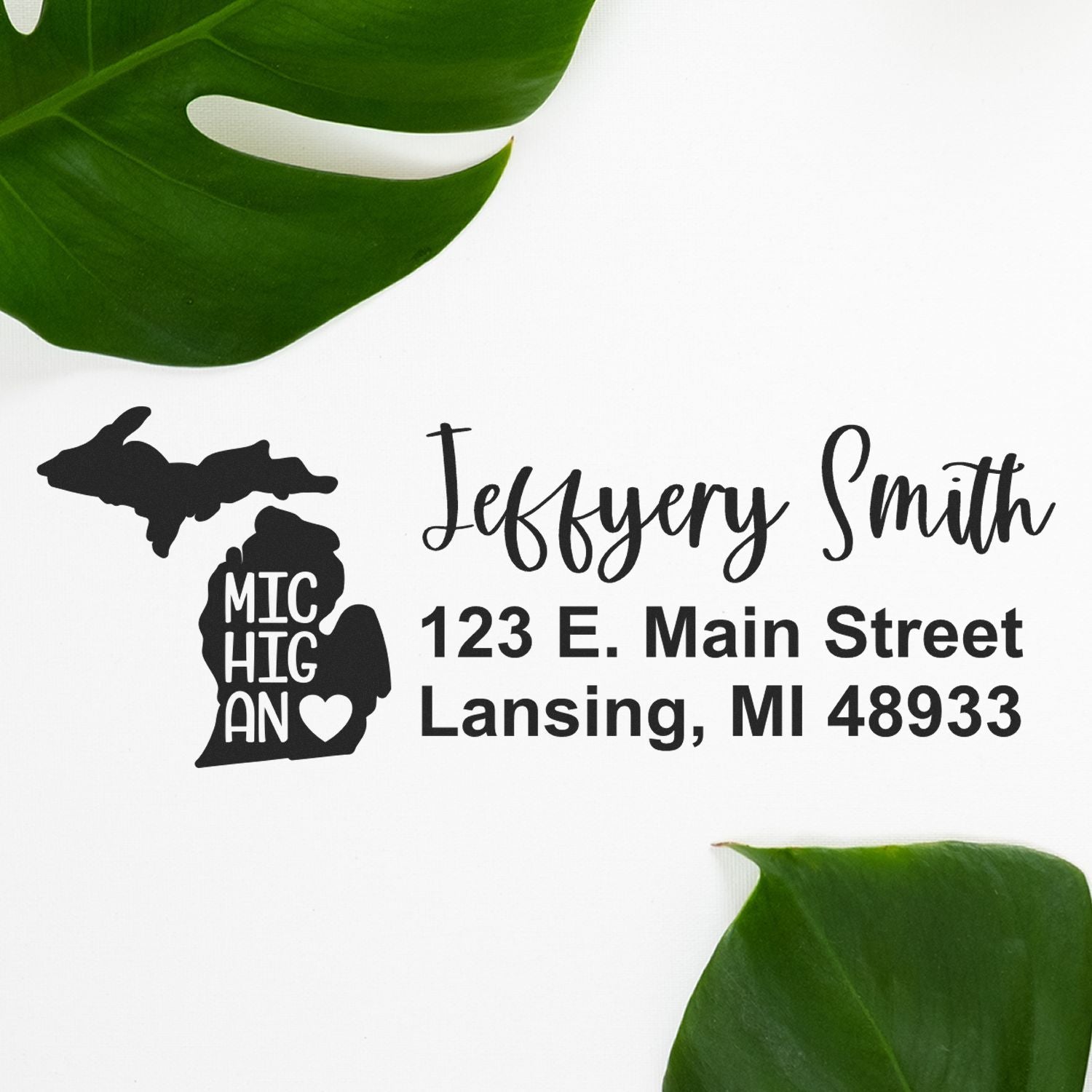 Image of the Michigan State Love Personalized Address Stamp featuring a silhouette of Michigan with Michigan text and a heart, alongside a sample address in elegant script on a white background.