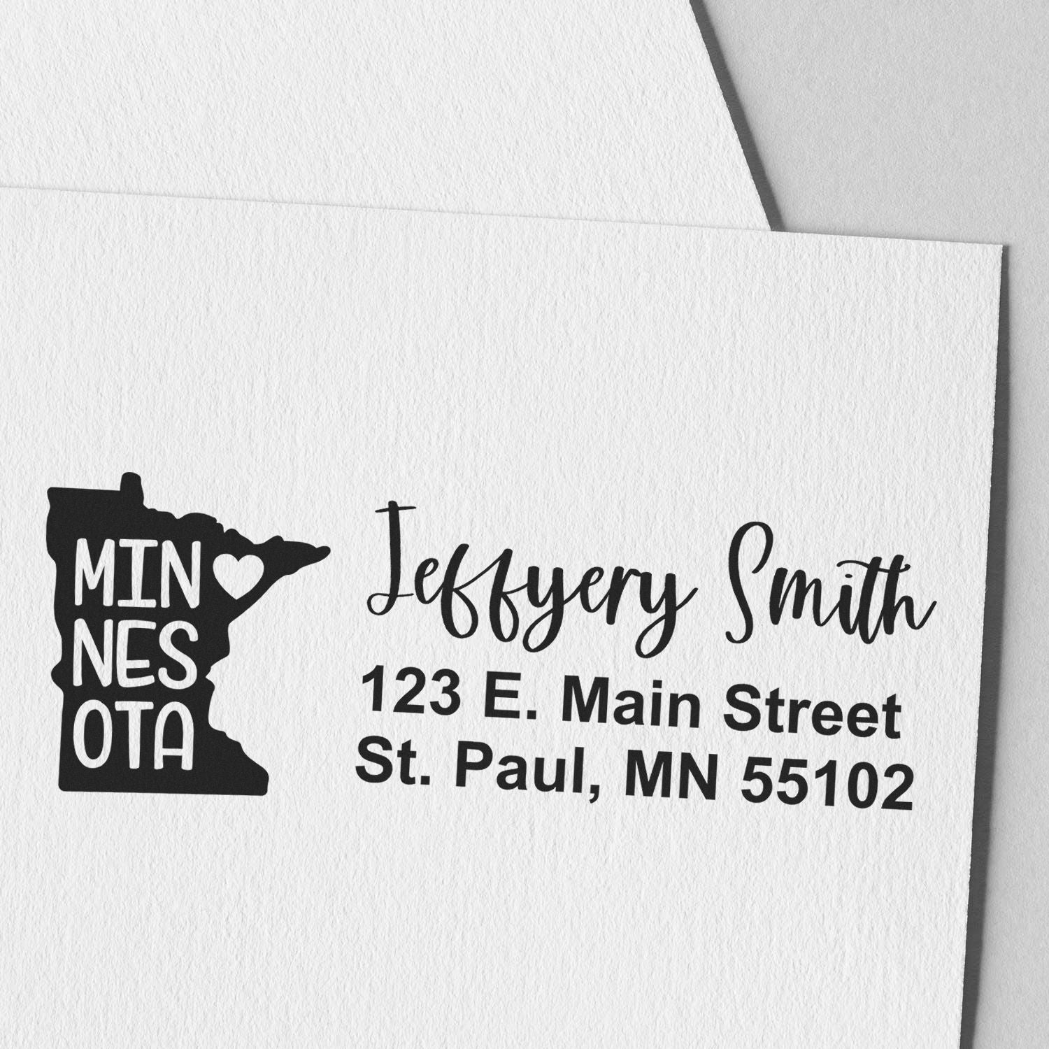 Minnesota State Love Personalized Address Stamp featuring a state outline with heart, personalized with Jeffery Smith, 123 E. Main Street, St. Paul, MN 55102 in elegant font on white paper.