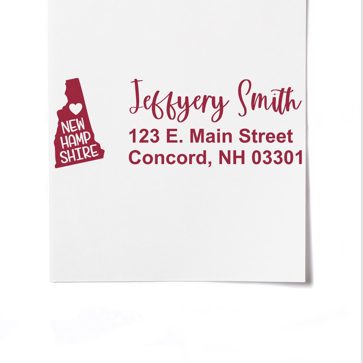 State Love of New Hampshire Custom Address Stamp Self-Inking on white paper, featuring a red state outline and personalized address for Jeffery Smith, Concord, NH.