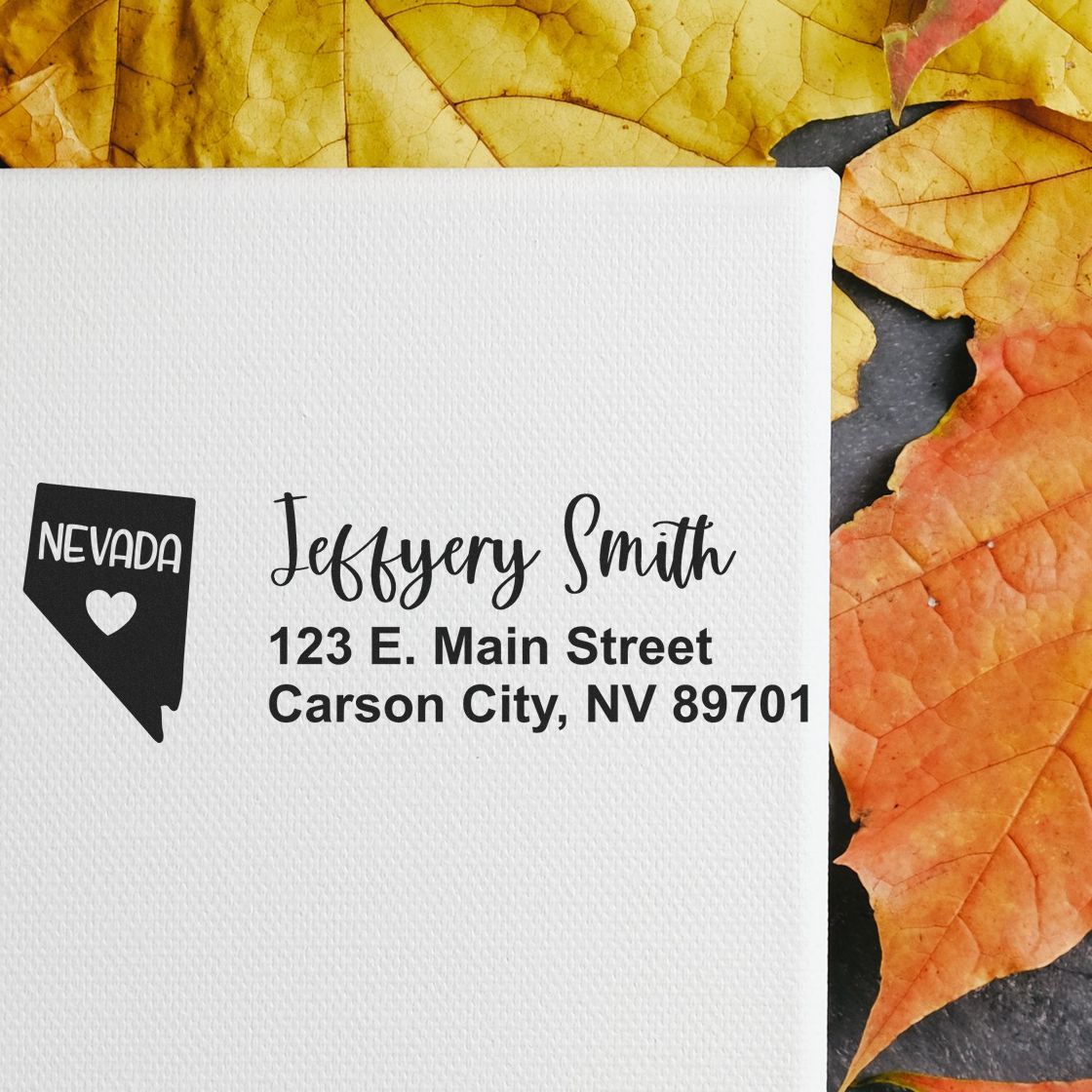 PSI Pre-Inked Nevada State Love Customized Address Stamp on white paper with Jeffery Smith, 123 E. Main Street, Carson City, NV 89701 text, surrounded by autumn leaves.