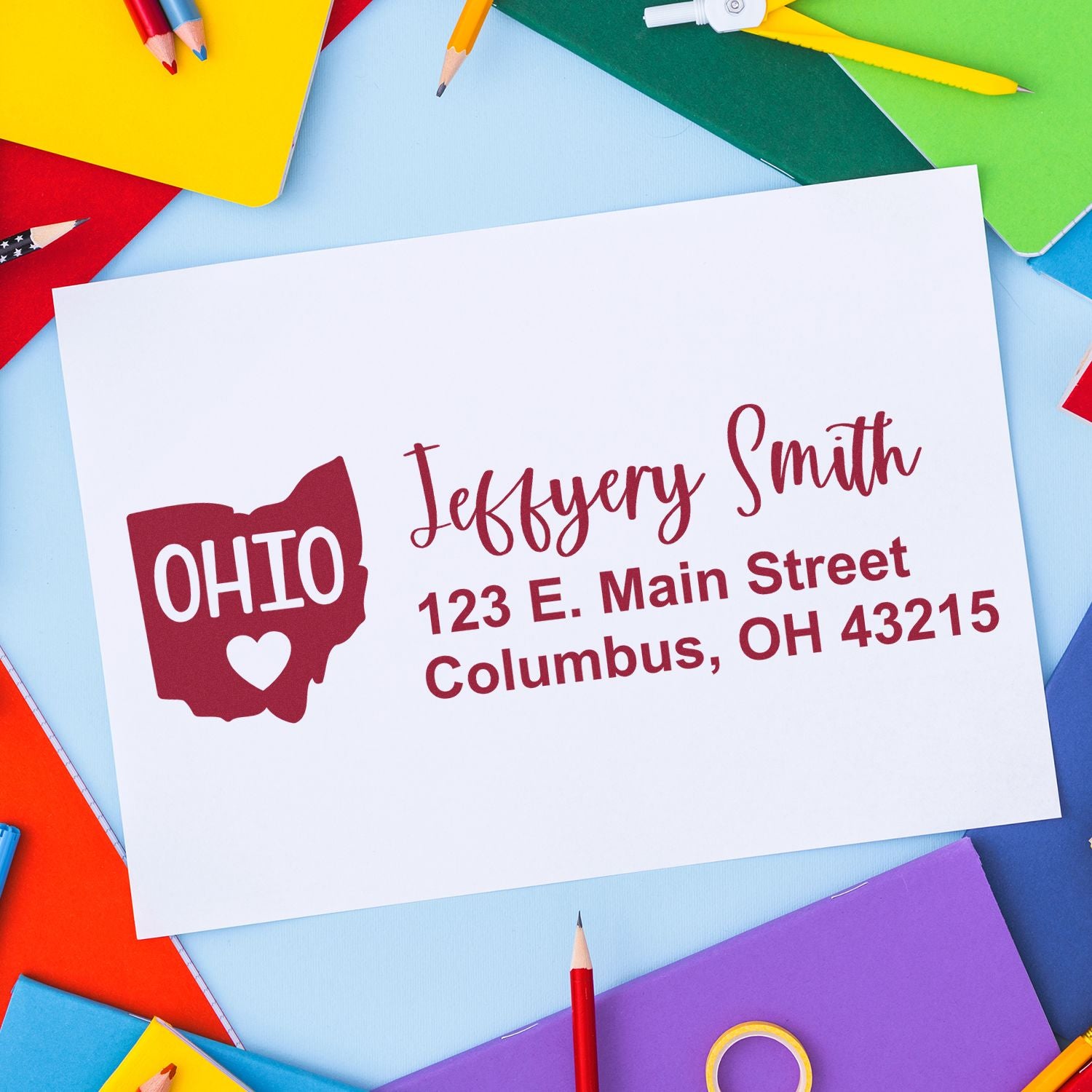 PSI Pre-Inked Ohio State Love Customized Address Stamp on colorful paper background, displaying Ohio with a heart and personalized address for Jeffery Smith, 123 E. Main Street, Columbus, OH 43215.