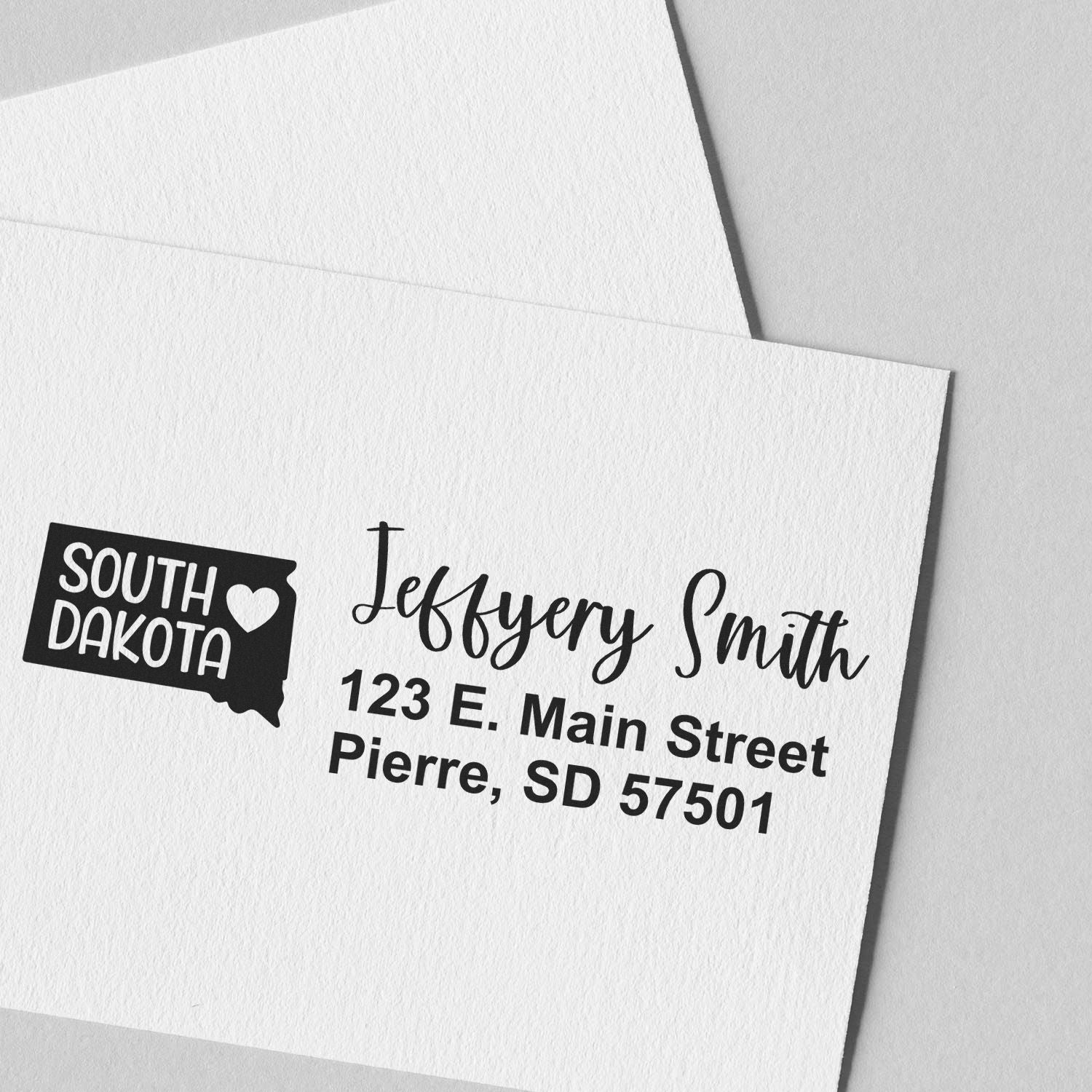 South Dakota State Love Personalized Address Stamp on white envelope, featuring a state outline with heart and custom name/address in elegant font. Perfect for adding a personal touch to mail.