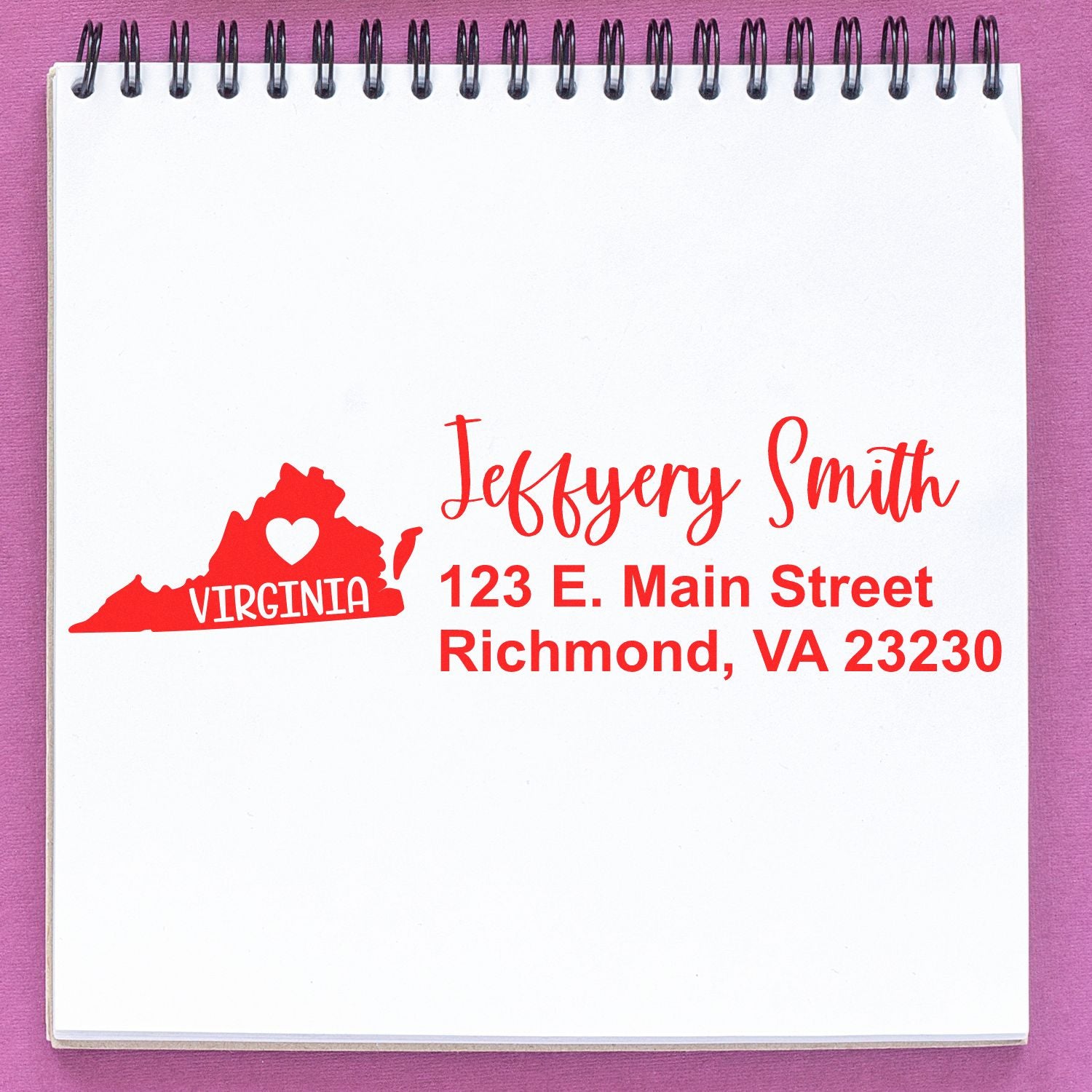 PSI Pre-Inked Virginia State Love Customized Address Stamp on a notepad, featuring a red Virginia state outline with a heart and personalized address in red text.