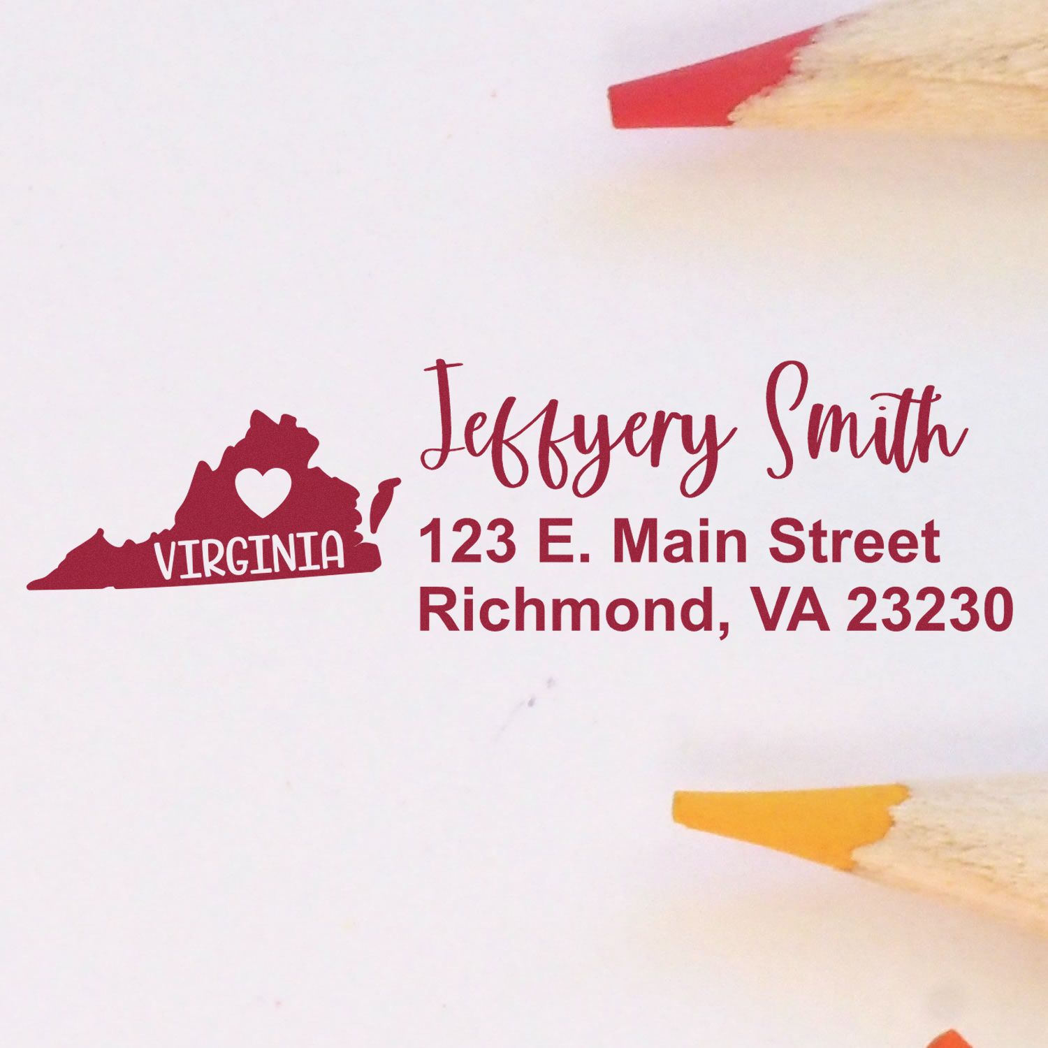 Virginia State Love Personalized Address Stamp featuring a heart in Virginia outline, with custom name and address in red ink on white paper, surrounded by colored pencils.