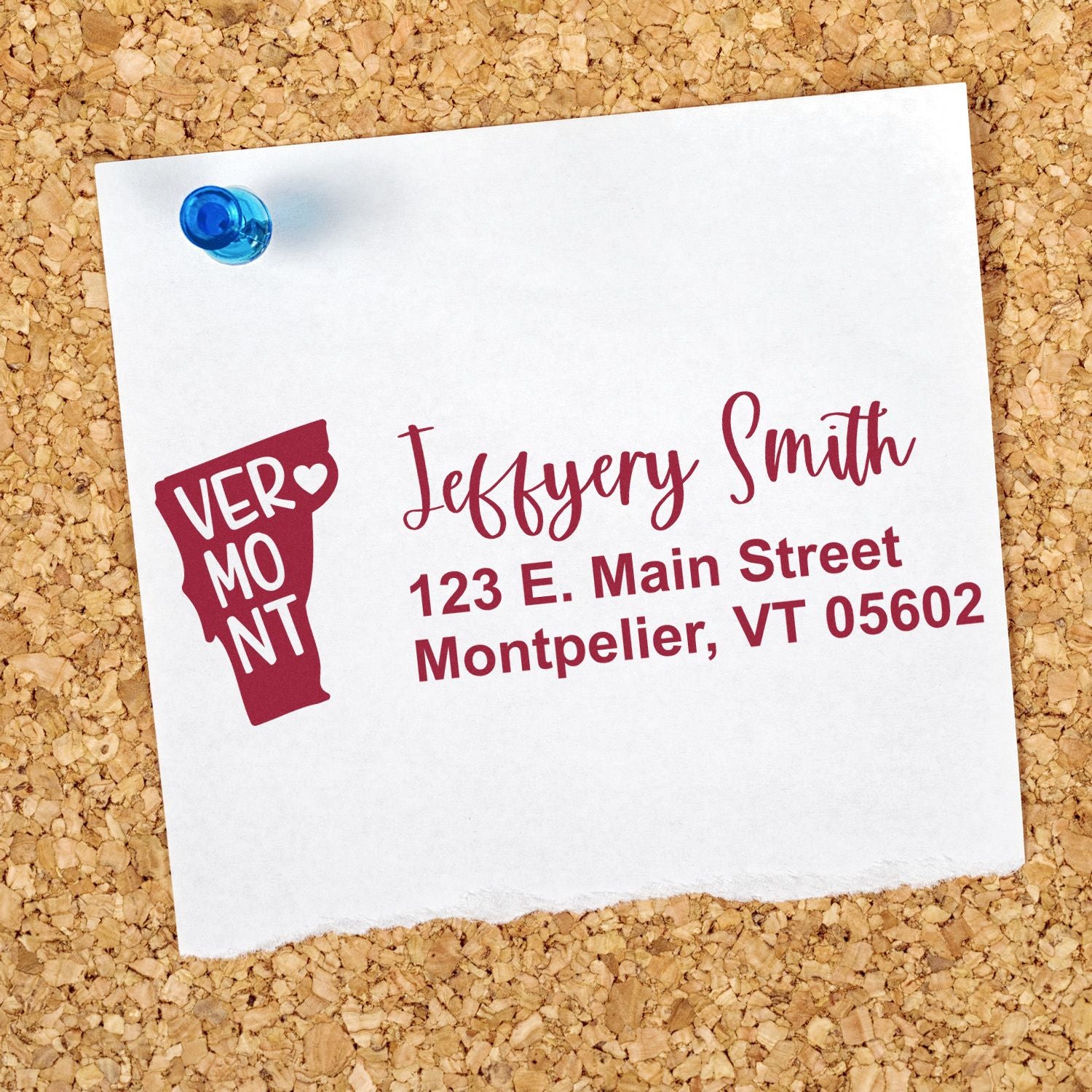 Vermont State Love Personalized Address Stamp on a corkboard, featuring a heart-shaped Vermont outline and custom address in elegant script.