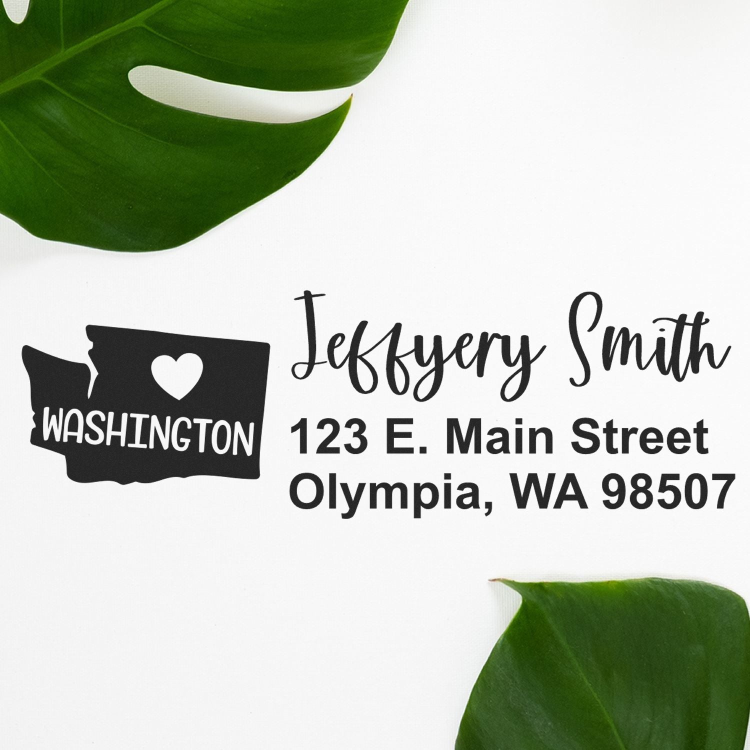 Washington State Love Personalized Address Stamp featuring a heart and state outline, with custom name and address in elegant script. Displayed on a white background with green leaves.