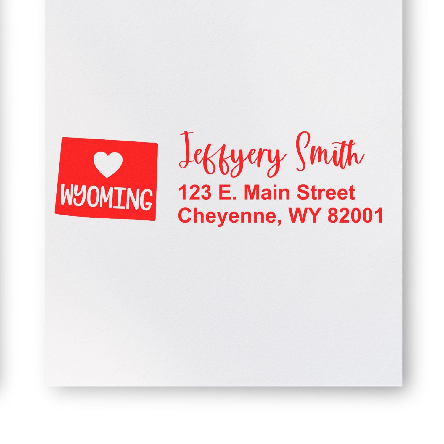 Wyoming State Love Personalized Address Stamp in red ink on white paper, featuring a heart and the word Wyoming with sample address: Jeffery Smith, 123 E. Main Street, Cheyenne, WY 82001.