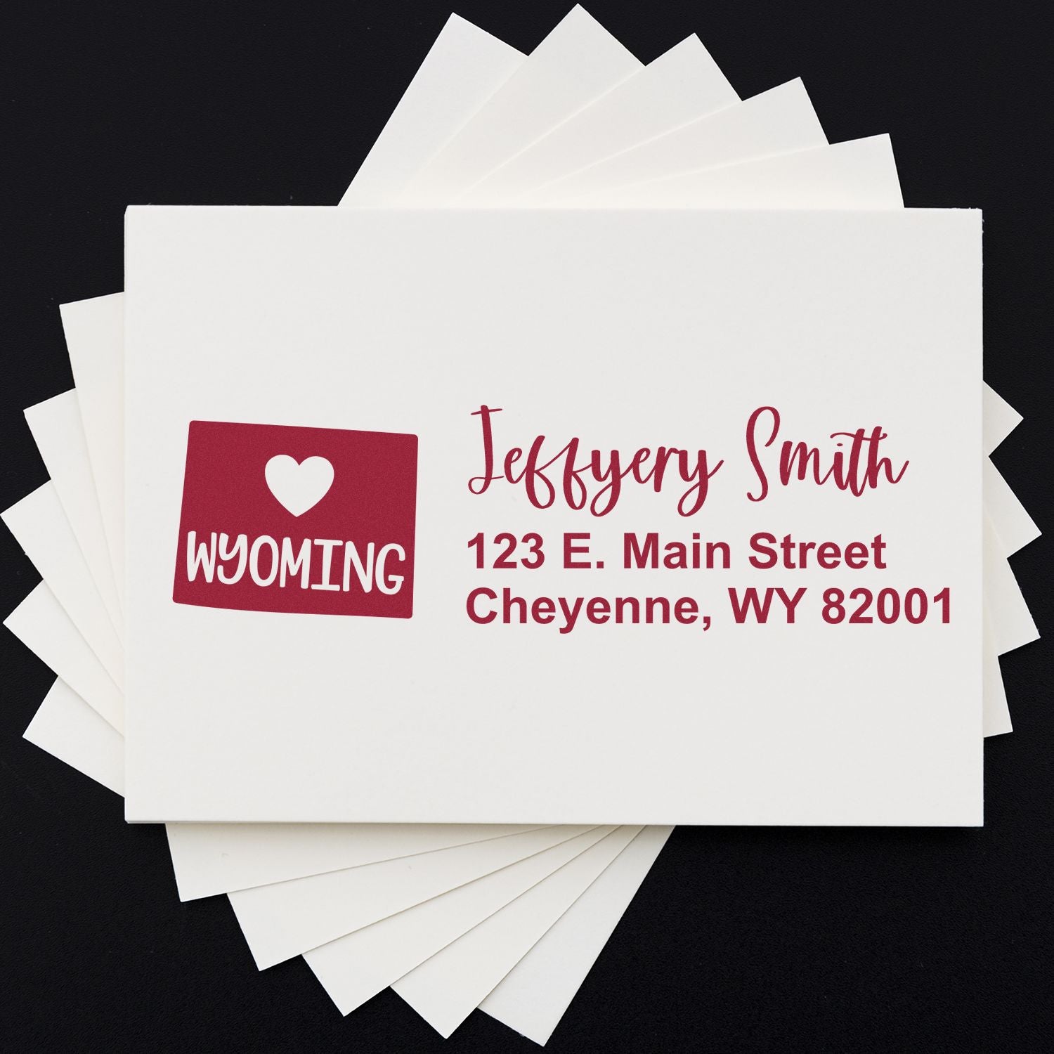 Wyoming State Love Personalized Address Stamp on white envelopes, featuring a heart and Wyoming design with red text for a custom address.