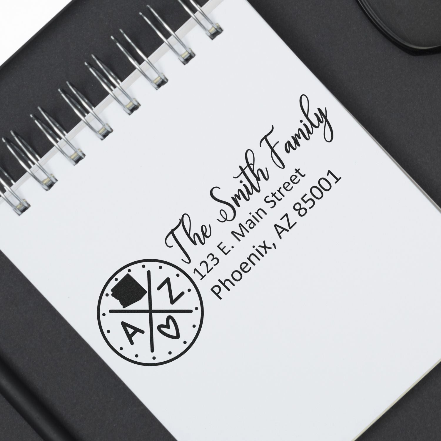 Self-Inking State Love of Arizona Custom Address Stamp on a notepad, displaying The Smith Family, 123 E. Main Street, Phoenix, AZ 85001 with a heart and Arizona state outline design.