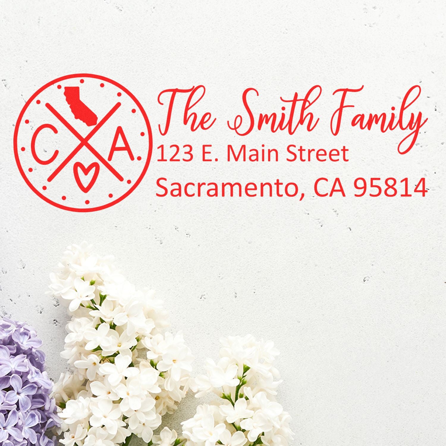 Self-Inking State Love of California Custom Address Stamp featuring The Smith Family with a red California design, address, and floral accents on a light background.