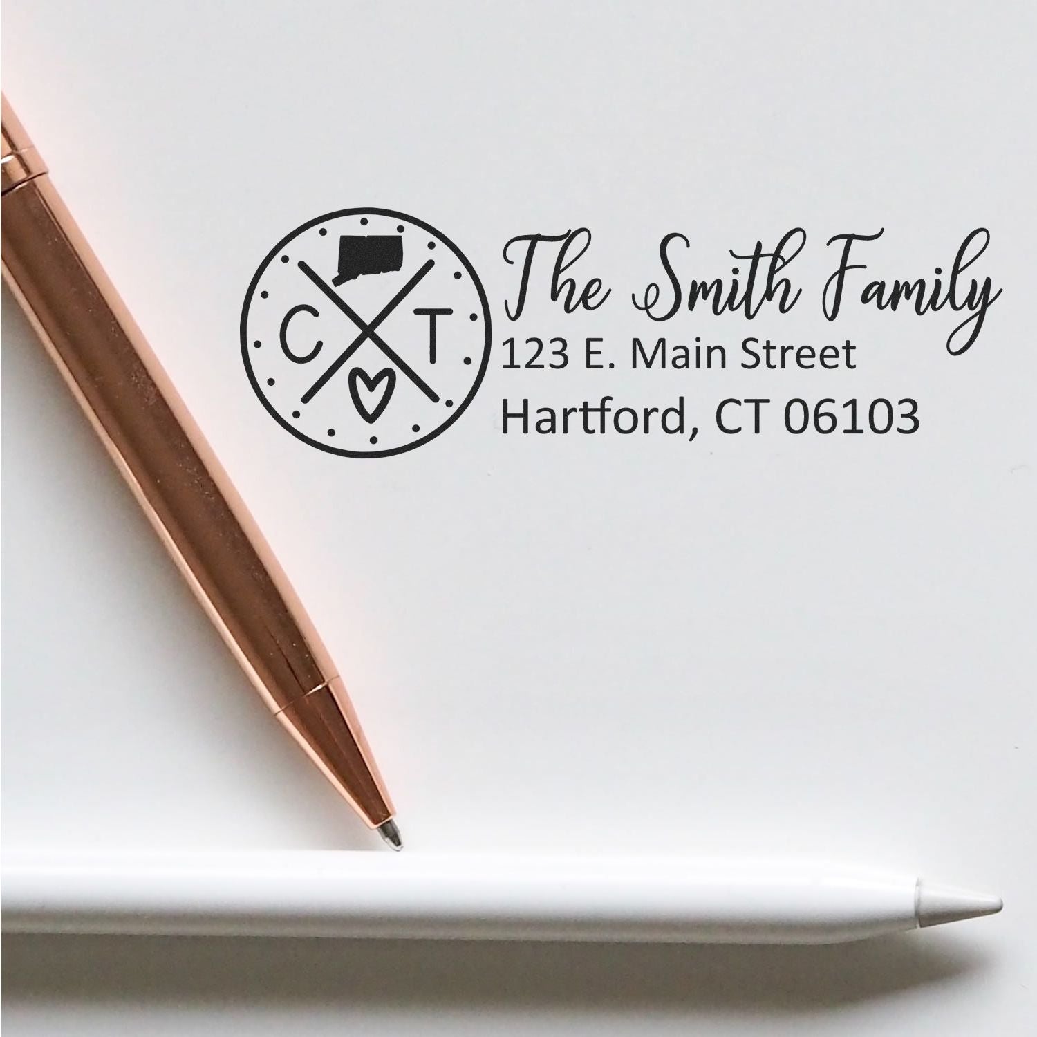 Connecticut State Pride Customized Address Stamp featuring a circular design with CT and a heart, personalized with The Smith Family address. Displayed with a rose gold and white pen.