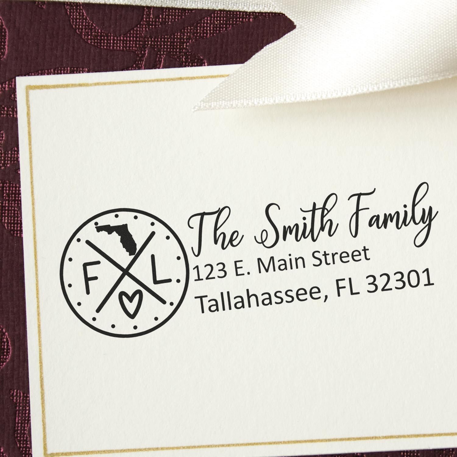 PSI Pre-Inked Florida State Pride Customized Address Stamp on an envelope, featuring a circular design with FL and a heart, alongside personalized address details for the Smith Family in Tallahassee.