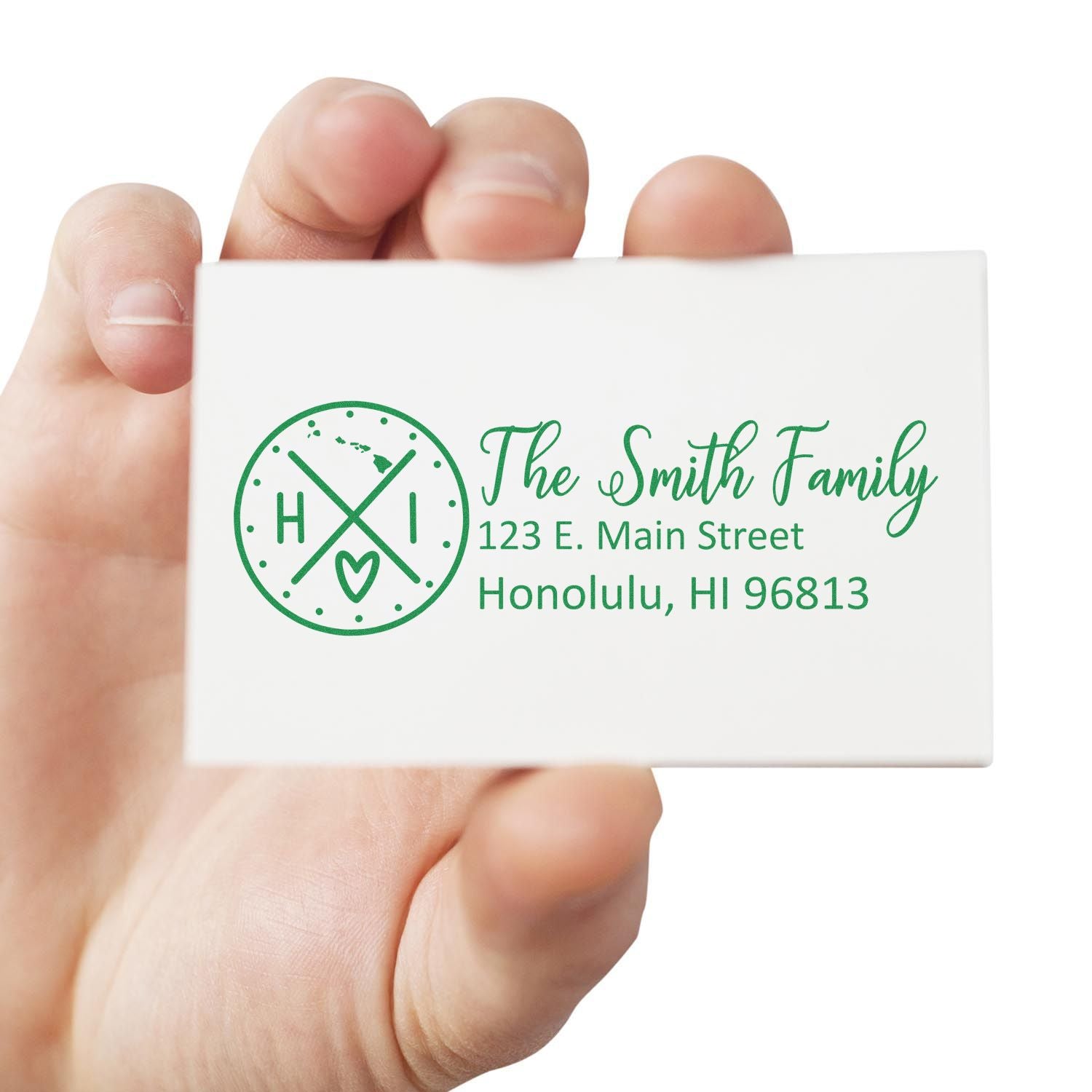 Hand holding a card with The Smith Family, 123 E. Main Street, Honolulu, HI 96813 in green, featuring a Hawaii-themed design. Showcasing the Hawaii State Pride Customized Address Stamp.