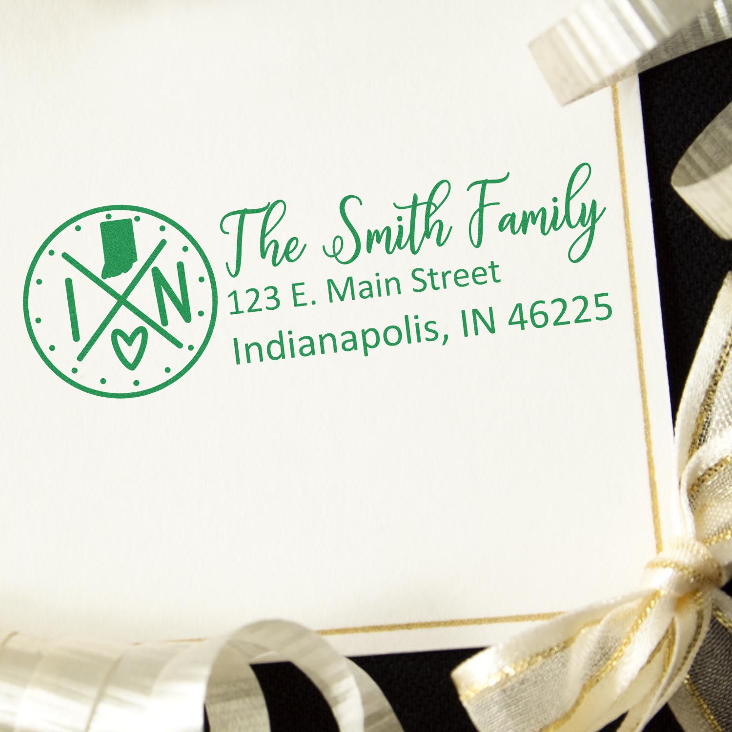 Indiana State Pride Customized Address Stamp on an envelope with a green design, featuring a family name and address, surrounded by gold and black ribbon.