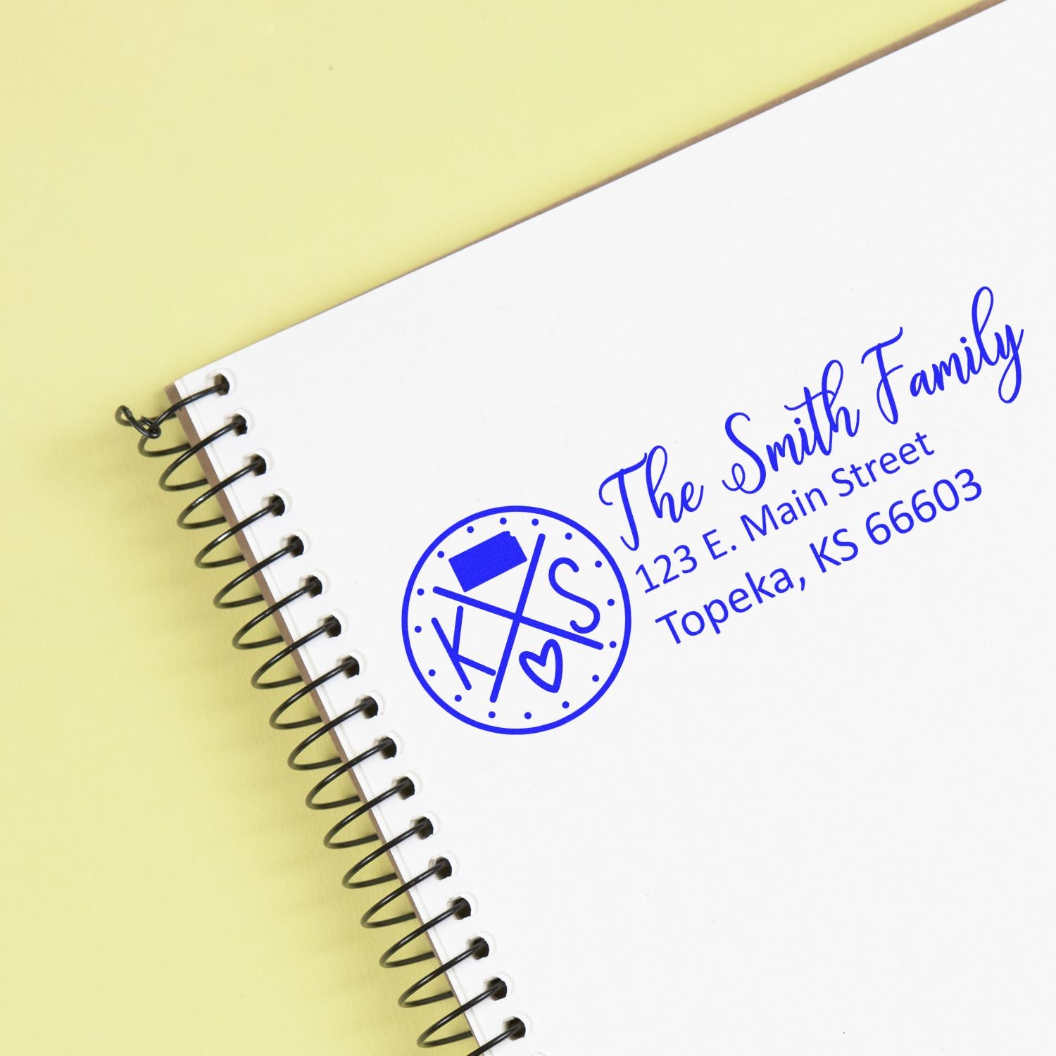 Kansas State Pride Customized Address Stamp on a notebook, featuring a blue design with The Smith Family and an address in Topeka, KS. The stamp includes a state outline and heart symbol.