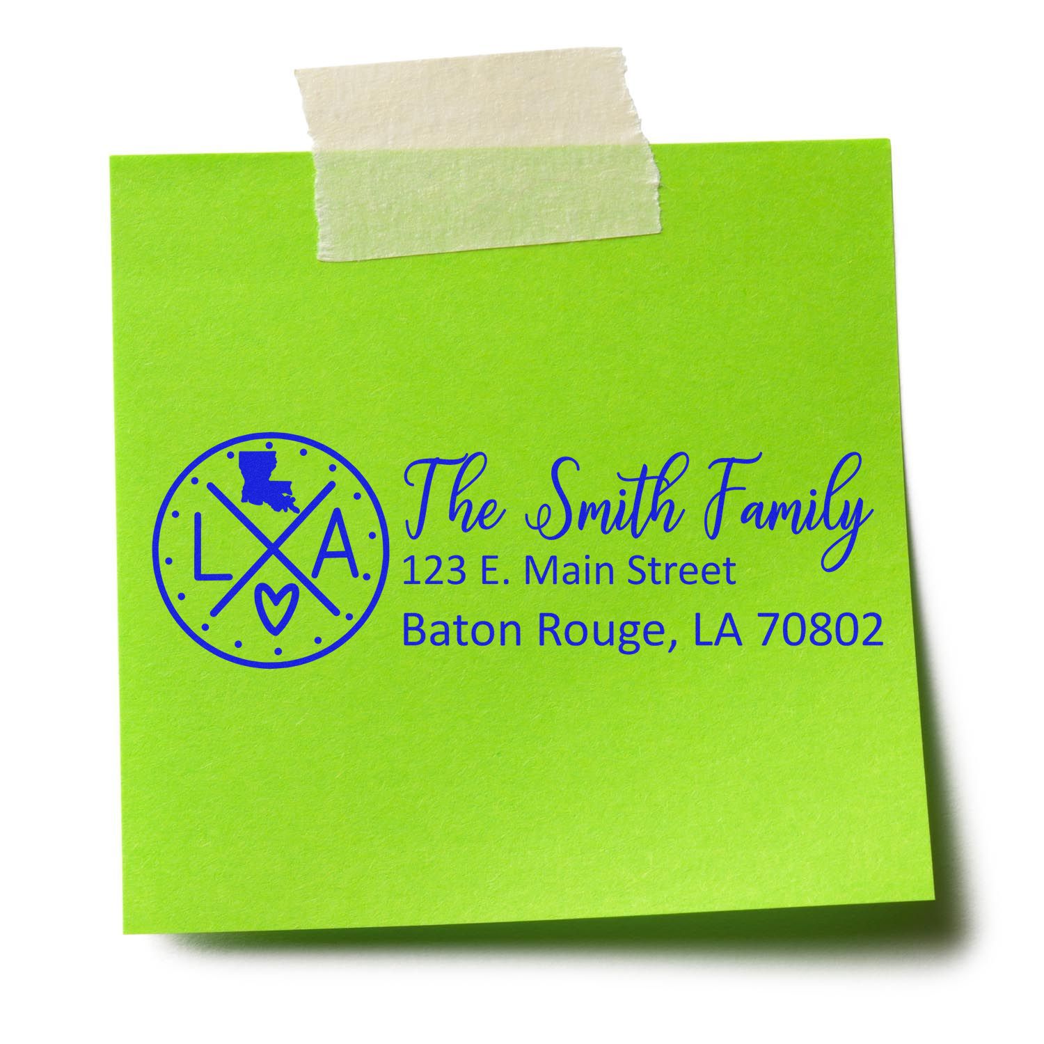 Green sticky note with a blue PSI Pre-Inked Louisiana State Pride Customized Address Stamp design, featuring a map outline, LA initials, and sample address for The Smith Family in Baton Rouge, LA.