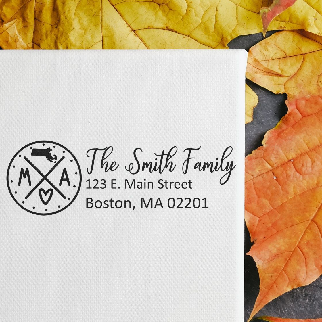 Self-Inking State Love of Massachusetts Custom Address Stamp on white paper with The Smith Family address, surrounded by autumn leaves.