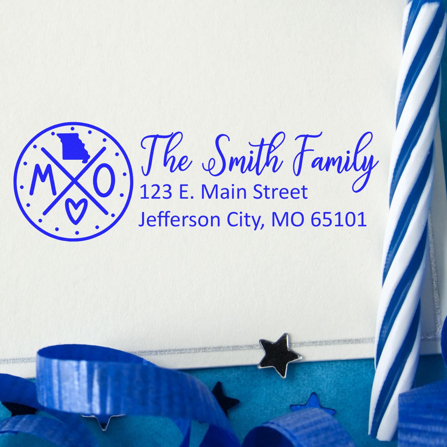 Missouri State Pride Customized Address Stamp on an envelope with blue and white decor, featuring a circular design with MO and a heart, personalized for The Smith Family in blue ink.