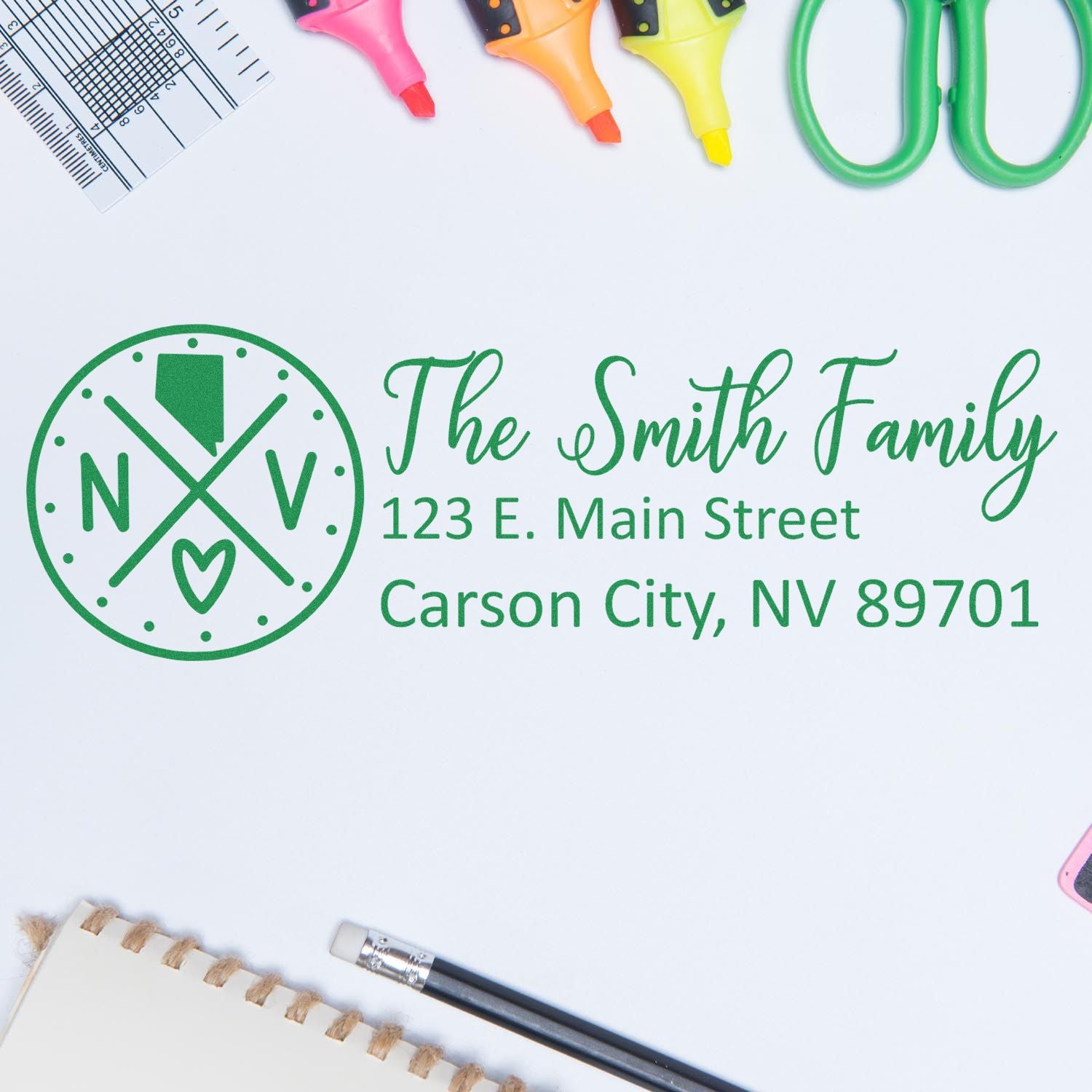 Nevada State Pride Customized Address Stamp featuring 'The Smith Family' and address in green ink on a white background, surrounded by office supplies like scissors and highlighters.