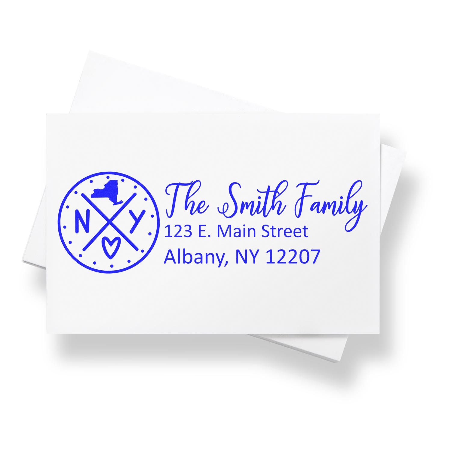 New York State Pride Customized Address Stamp featuring a circular design with NY state outline, heart, and arrows. Displays The Smith Family with address in blue on a white envelope.