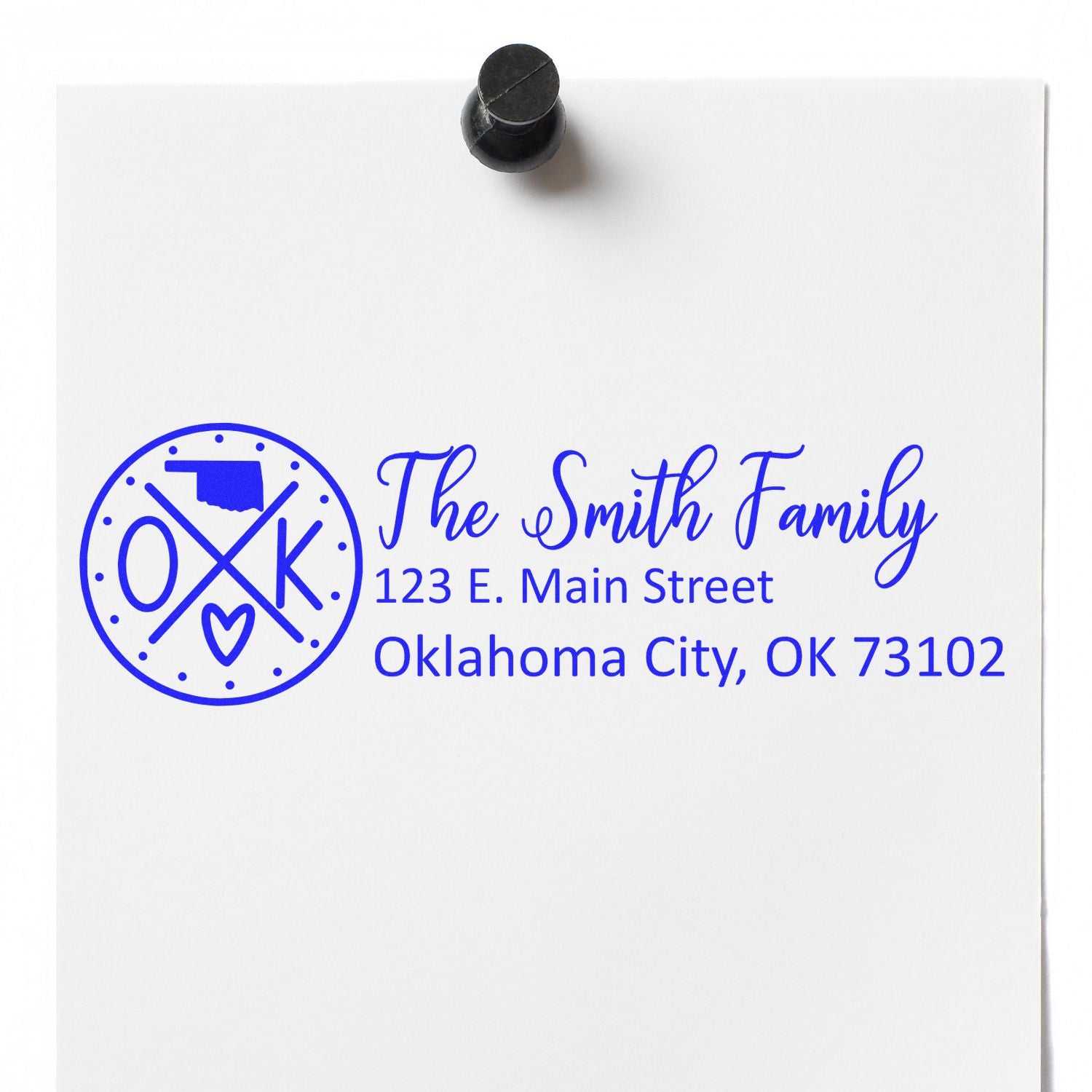 Image of a Self-Inking State Love of Oklahoma Custom Address Stamp imprint on white paper, featuring a circular OK design with a heart and state outline, personalized with a family name and address.