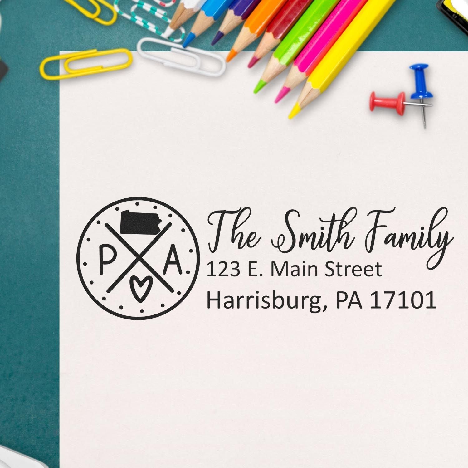 Pennsylvania State Pride Customized Address Stamp on an envelope with colorful pencils and paperclips. The stamp features a Pennsylvania map and personalized address details.