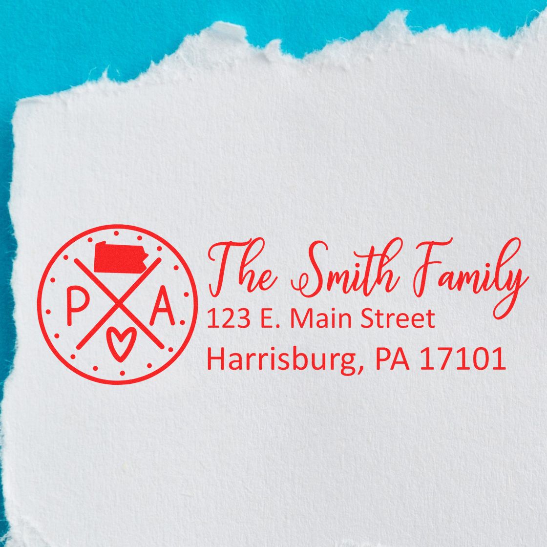 Red Pennsylvania State Pride Customized Address Stamp with crossed lines, state outline, and heart. Personalized with The Smith Family, 123 E. Main Street, Harrisburg, PA 17101 on torn white paper.