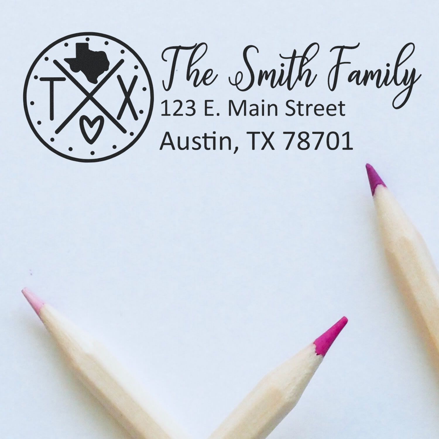 PSI Pre-Inked Texas State Pride Customized Address Stamp featuring a Texas-themed design with personalized address details. Shown on white paper with pink-tipped pencils nearby.