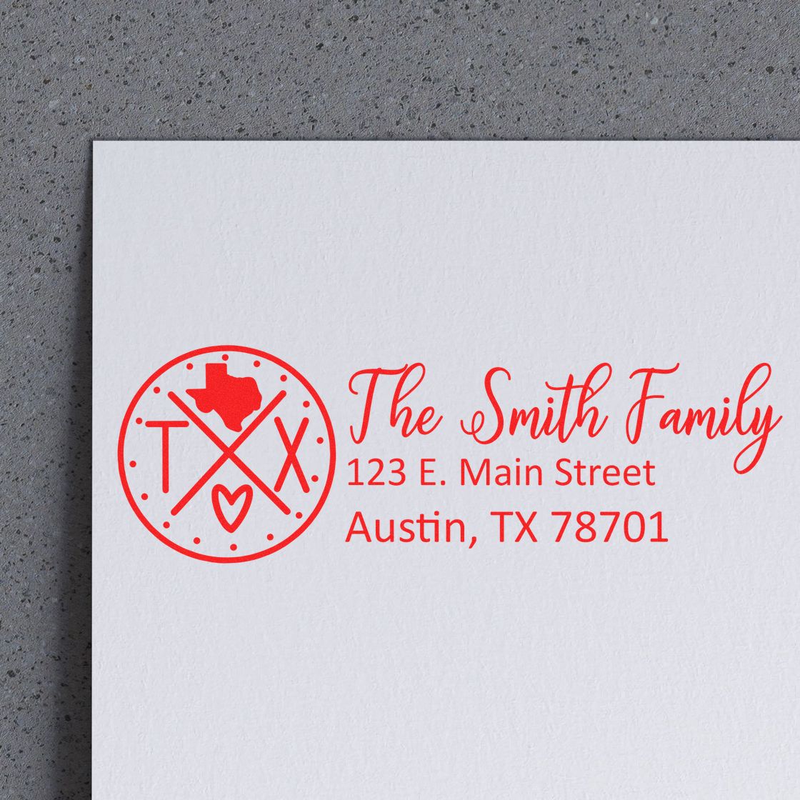 Self-Inking State Love of Texas Custom Address Stamp in red ink on white paper, featuring a Texas outline and heart design, with personalized address for the Smith Family in Austin, TX.