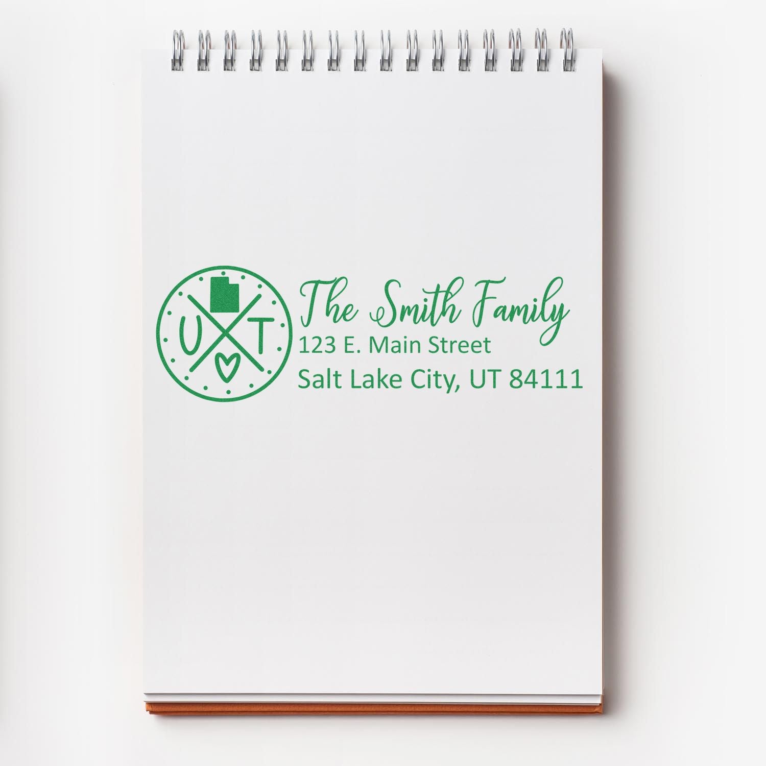 Self-Inking State Love of Utah Custom Address Stamp on notepad, featuring The Smith Family and a Utah-themed design with address: 123 E. Main Street, Salt Lake City, UT 84111, in green ink.