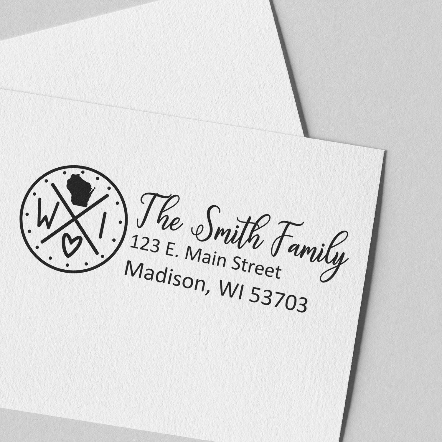 PSI Pre-Inked Wisconsin State Pride Customized Address Stamp on white paper, featuring a circular design with WI and a heart, alongside personalized address details for the Smith Family in Madison.