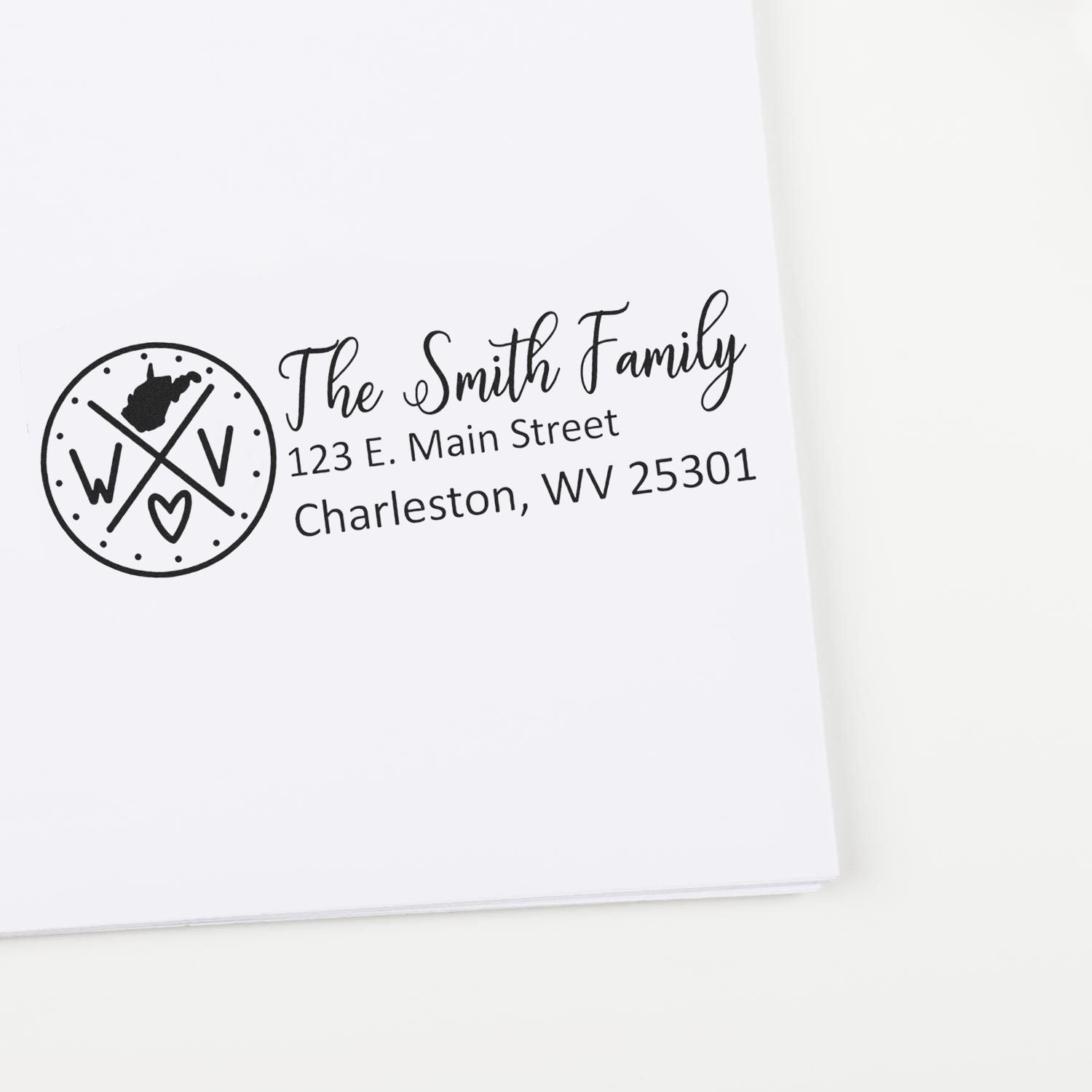 Self-Inking State Love of West Virginia Custom Address Stamp on white envelope, featuring a circular WV design with heart, personalized with The Smith Family and Charleston address.