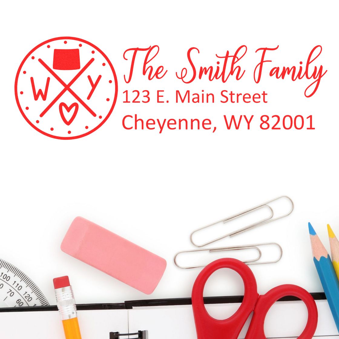 PSI Pre-Inked Wyoming State Pride Customized Address Stamp featuring a red design with 'The Smith Family' address, surrounded by office supplies like scissors, pencils, and paper clips.