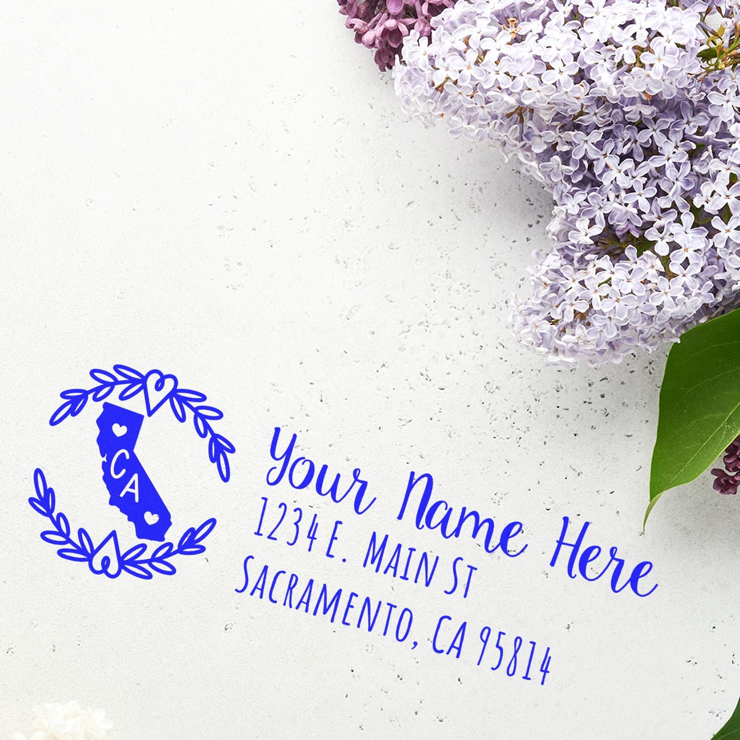 California State Custom Return Address Stamp on white paper with floral design, featuring a blue outline of California and personalized address text.