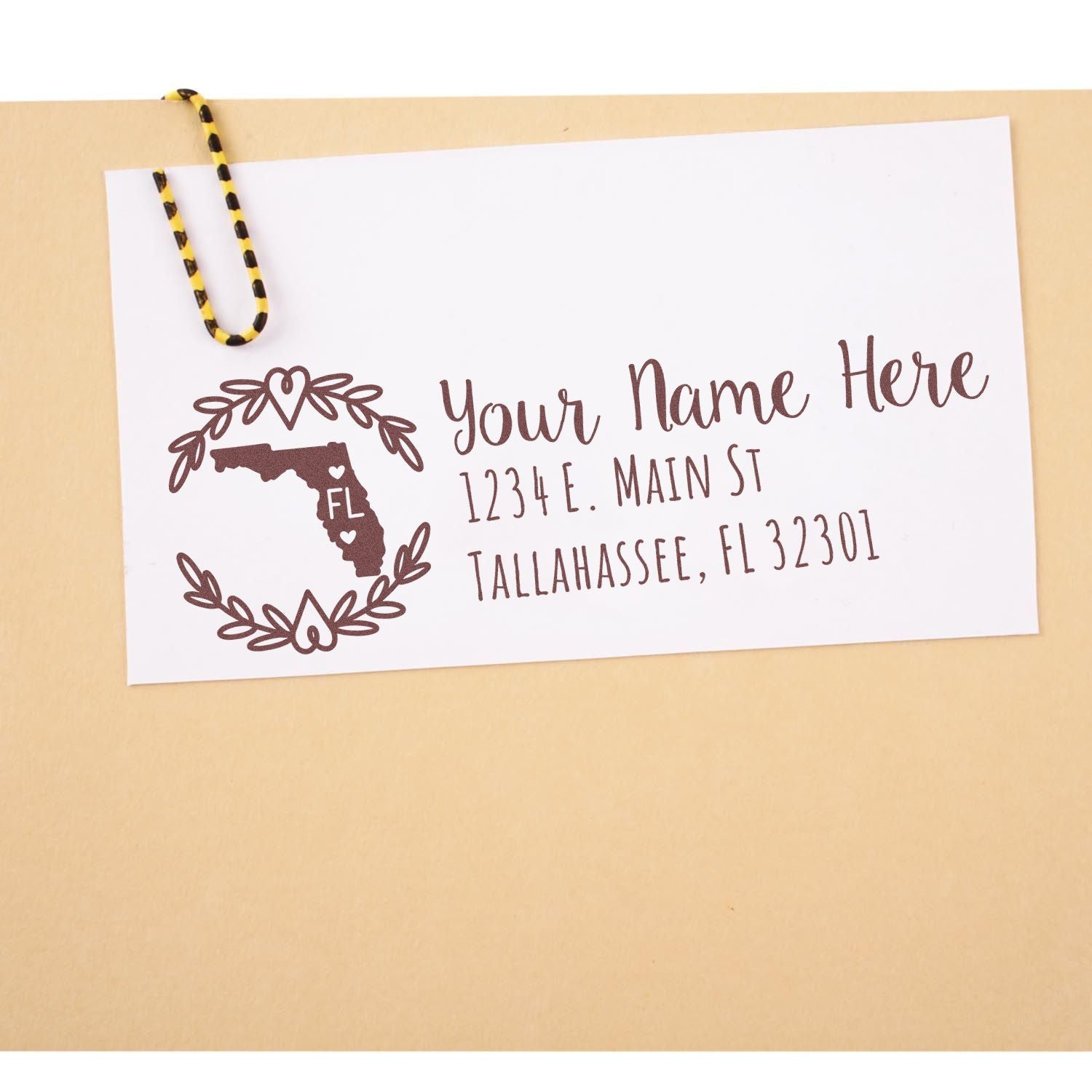 Envelope with a card stamped using the Self-Inking State Wreath of Florida Address Stamp, featuring a Florida map design and address details in elegant script.