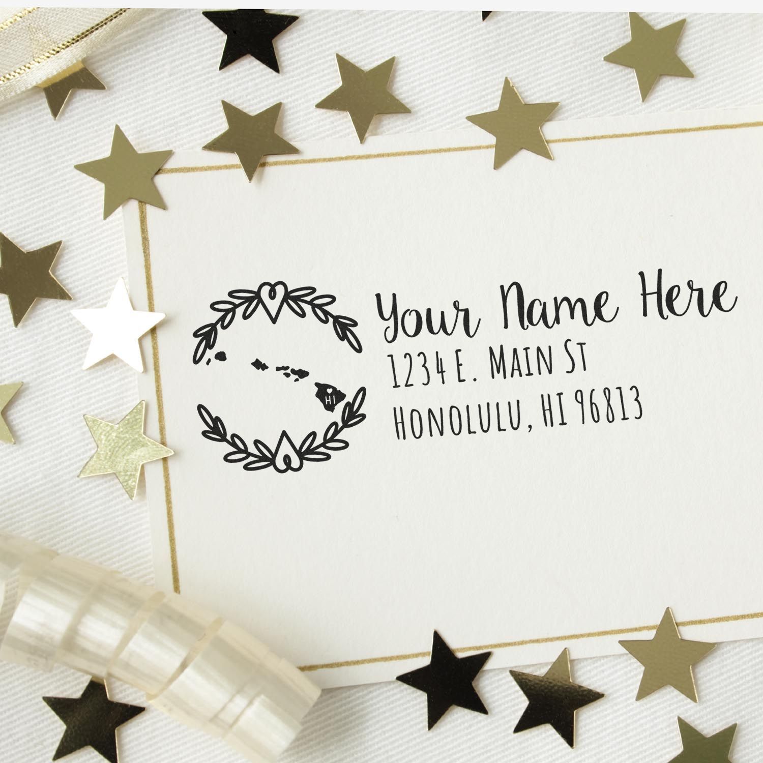 Hawaii State Custom Return Address Stamp on a white card with gold stars and ribbon, featuring a decorative wreath and sample address in elegant script.