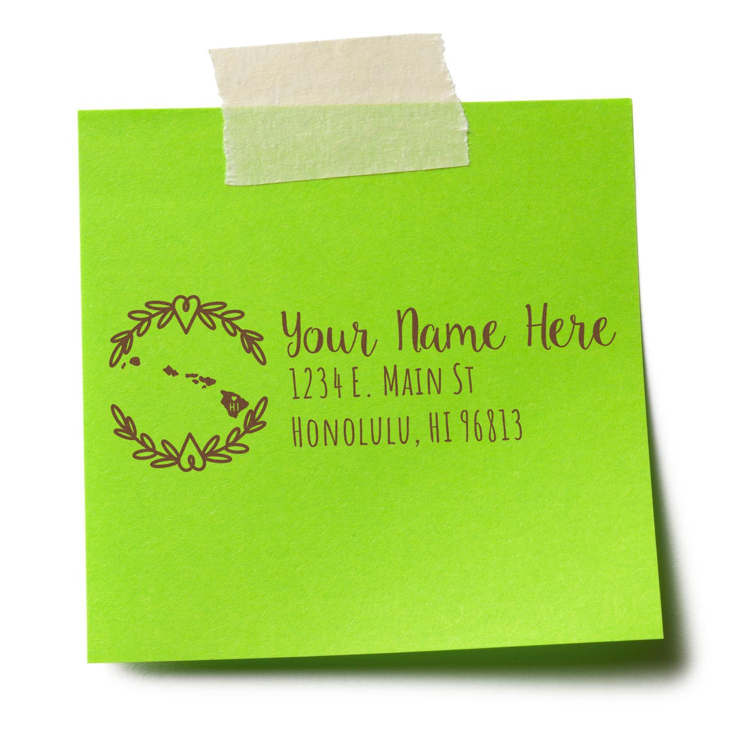 Green sticky note with Your Name Here, 1234 E. Main St, Honolulu, HI 96813 stamped in brown ink. Features a wreath design. Showcases the Self-Inking State Wreath of Hawaii Address Stamp.