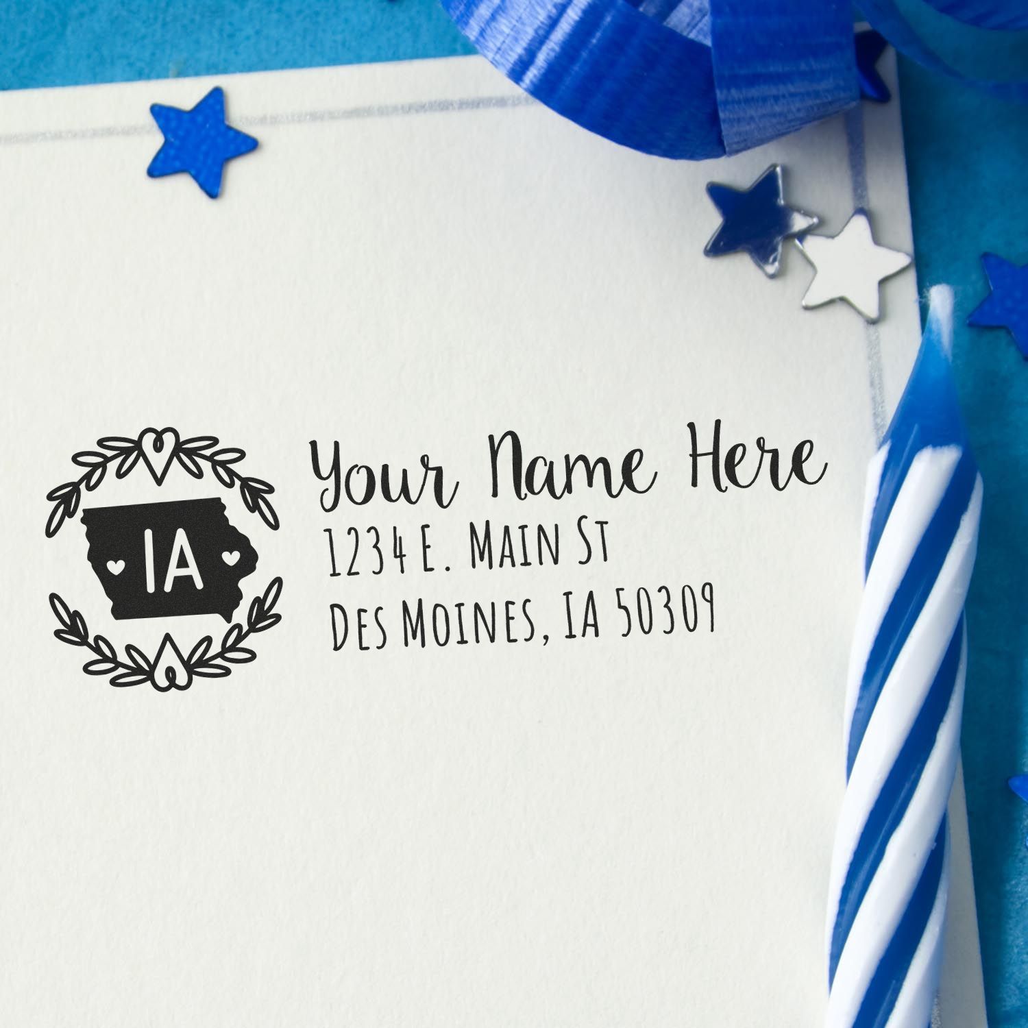 Self-Inking State Wreath of Iowa Address Stamp on an envelope with blue and silver decorations, featuring a wreath design and customizable address text.