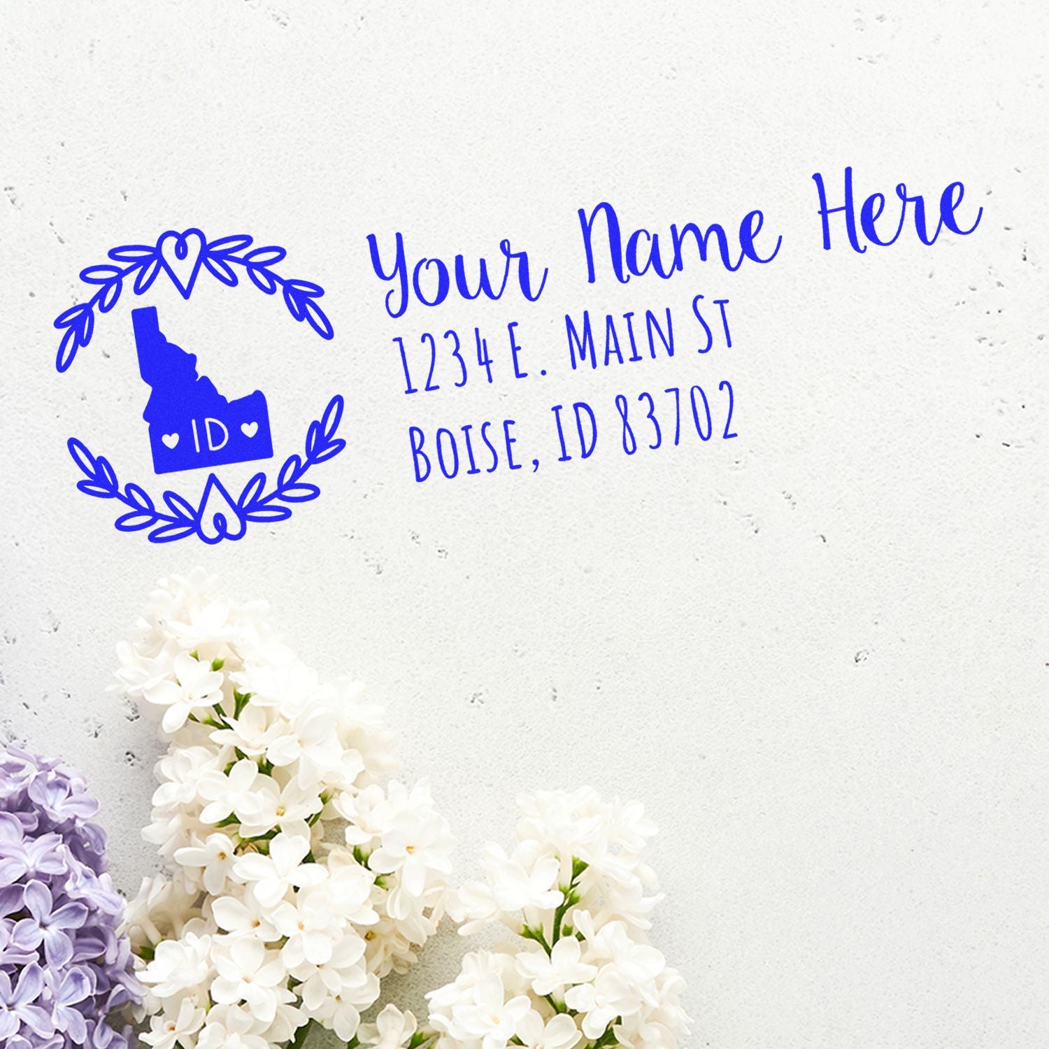 Idaho State Custom Return Address Stamp on white paper with floral border, featuring a blue Idaho map design and sample address text.