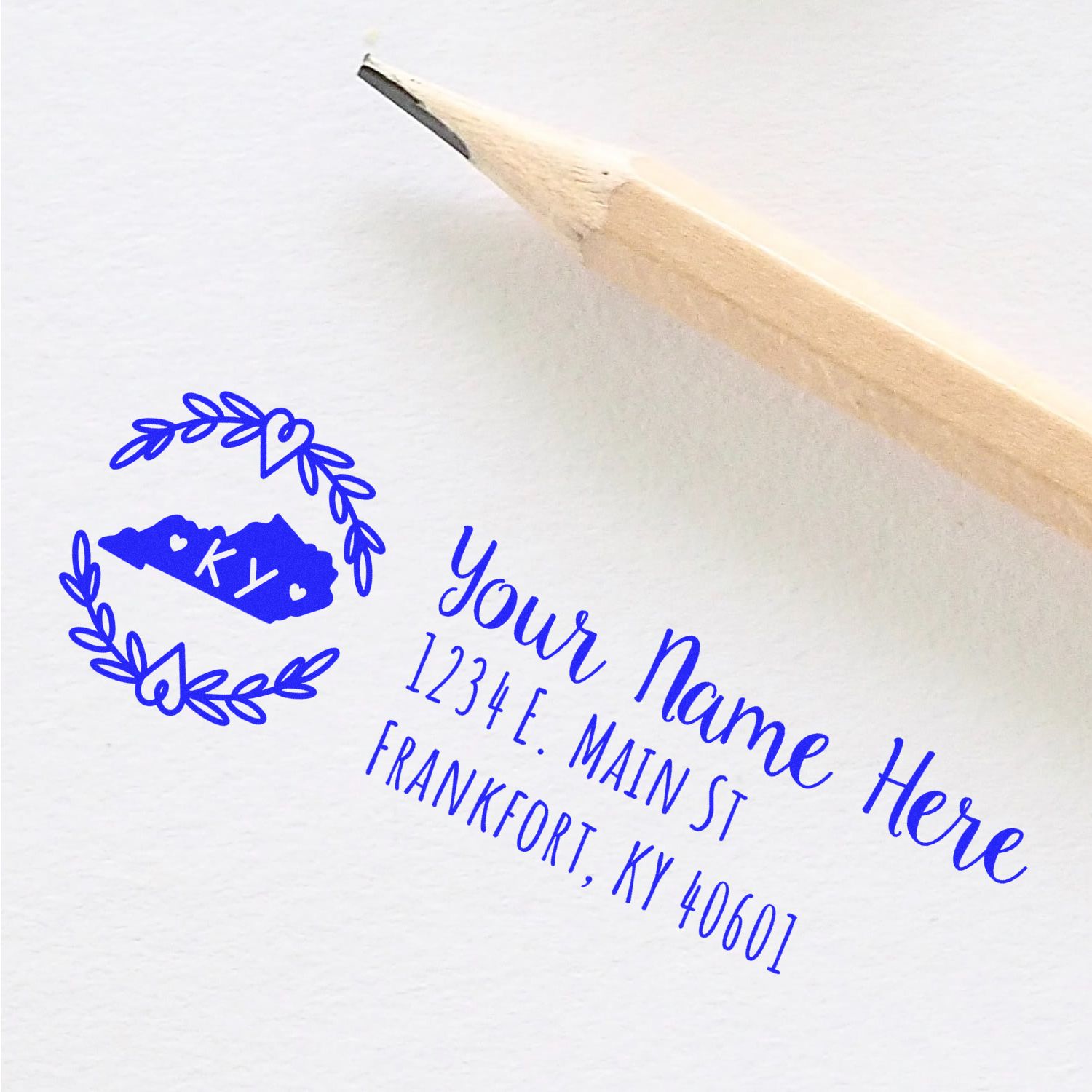 Kentucky State Custom Return Address Stamp in blue ink on white paper, featuring a pencil and a decorative state outline with KY inside.