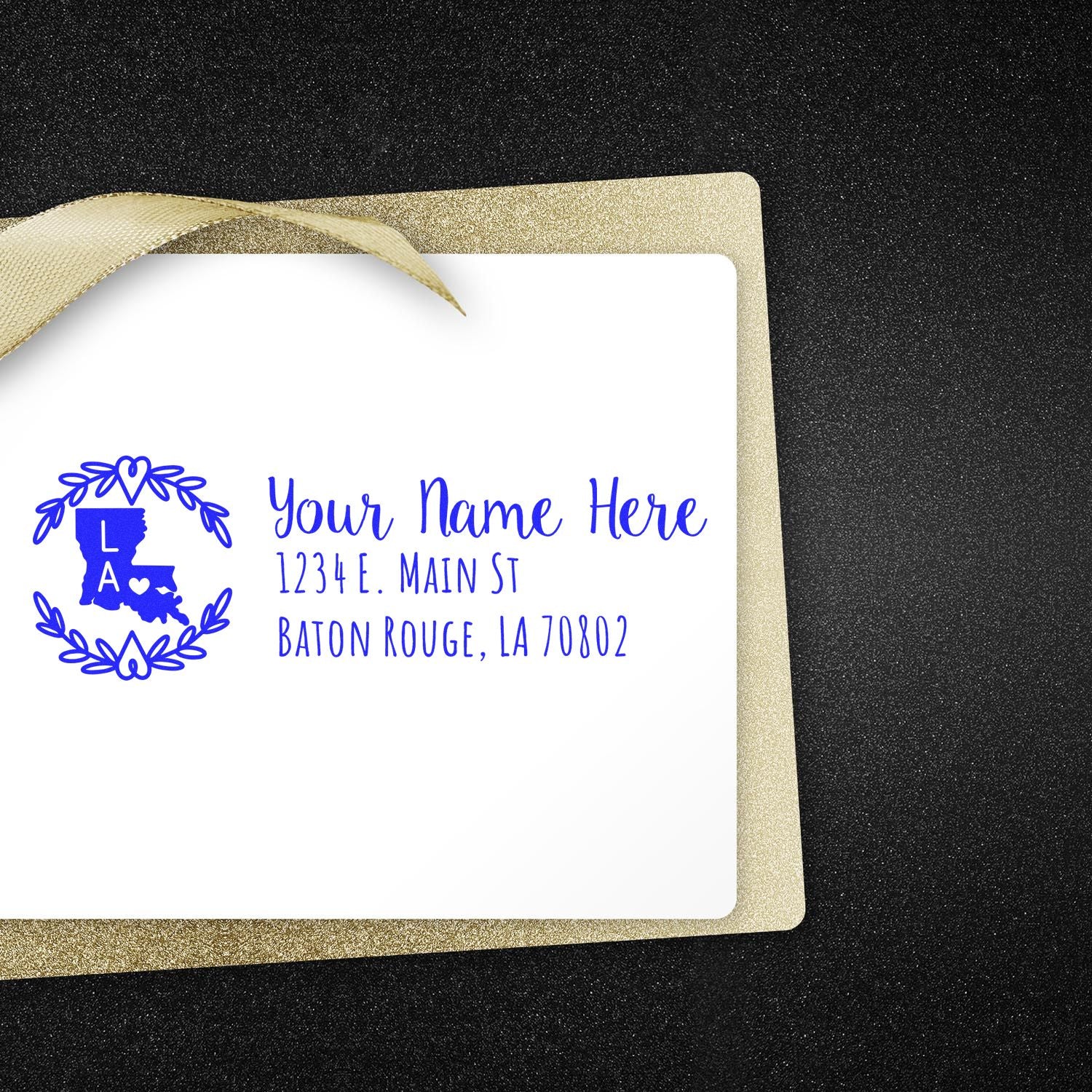 Slim Louisiana Personalized Pre-Inked Address Stamp on a white envelope with gold trim, featuring a blue design of the state and address text.