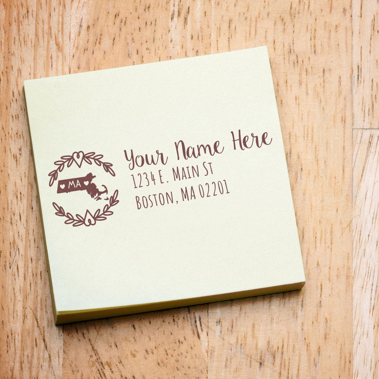 PSI Pre-Inked Massachusetts State Customized Address Stamp on a light green notepad, featuring a decorative state outline and sample address in elegant script.