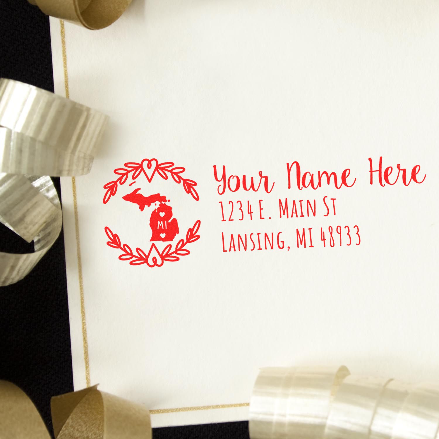 Michigan State Custom Return Address Stamp in red ink on an envelope, featuring a heart design around the state outline. Perfect for personalizing mail with a touch of Michigan pride.