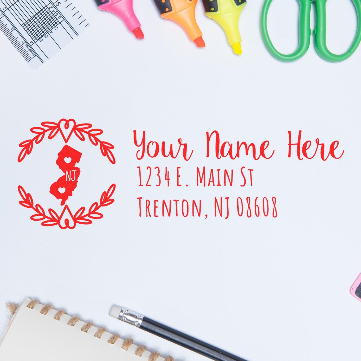 Slim New Jersey Personalized Pre-Inked Address Stamp on a desk with colorful stationery, featuring a red NJ state design and customizable address text.