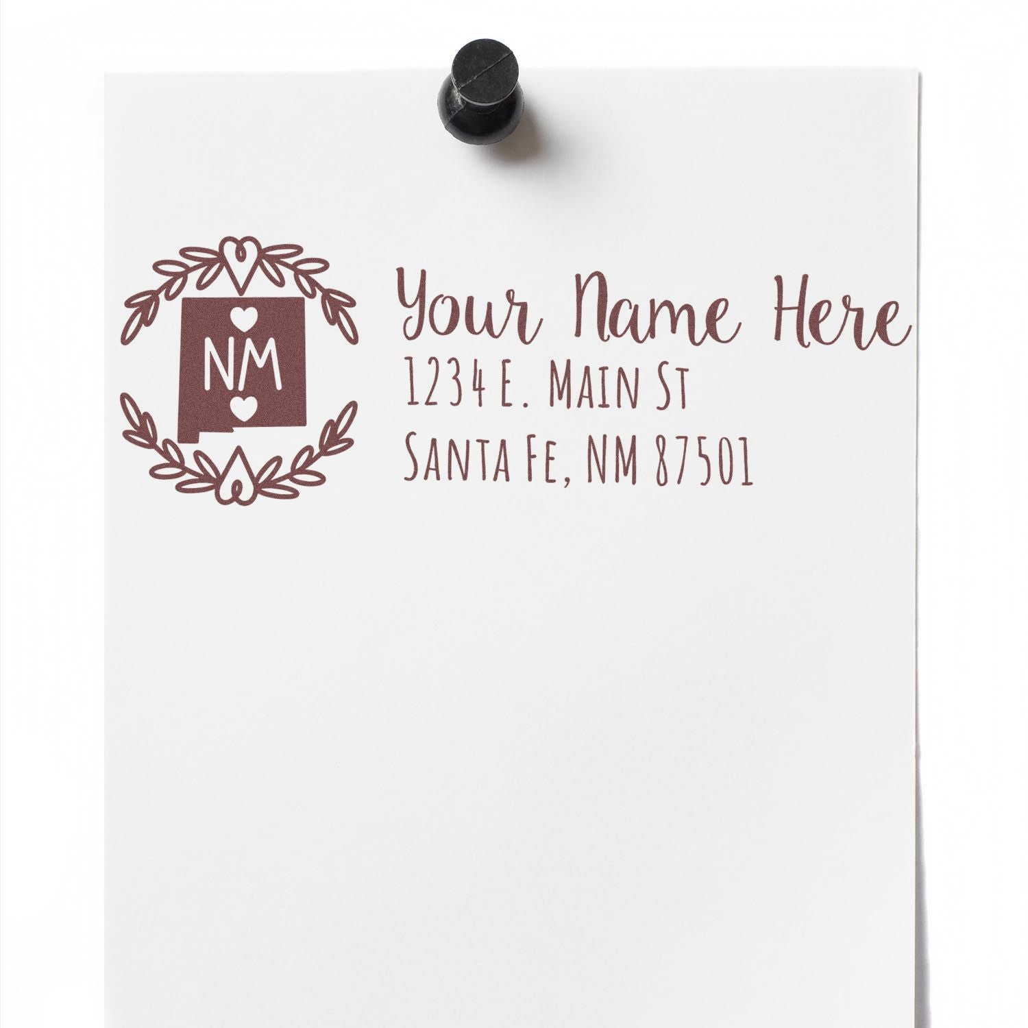 Self-Inking State Wreath of New Mexico Address Stamp on white paper, featuring a decorative NM state design with hearts, personalized address, and pinned to a board.