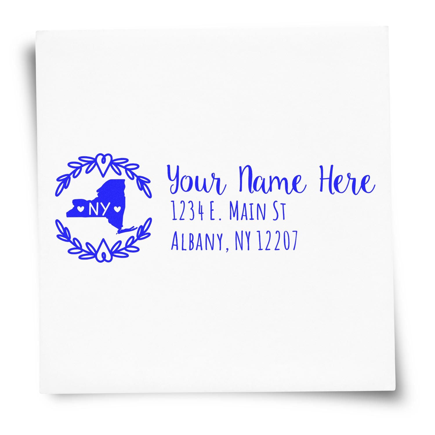 PSI Pre-Inked New York State Customized Address Stamp on white paper, featuring a blue design with a map outline, hearts, and sample text for name and address in Albany, NY.