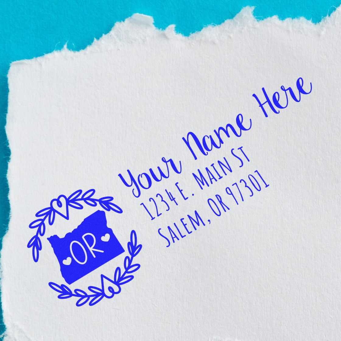 Oregon State Custom Return Address Stamp on white paper with blue ink, featuring a decorative Oregon state outline and space for personalized name and address.