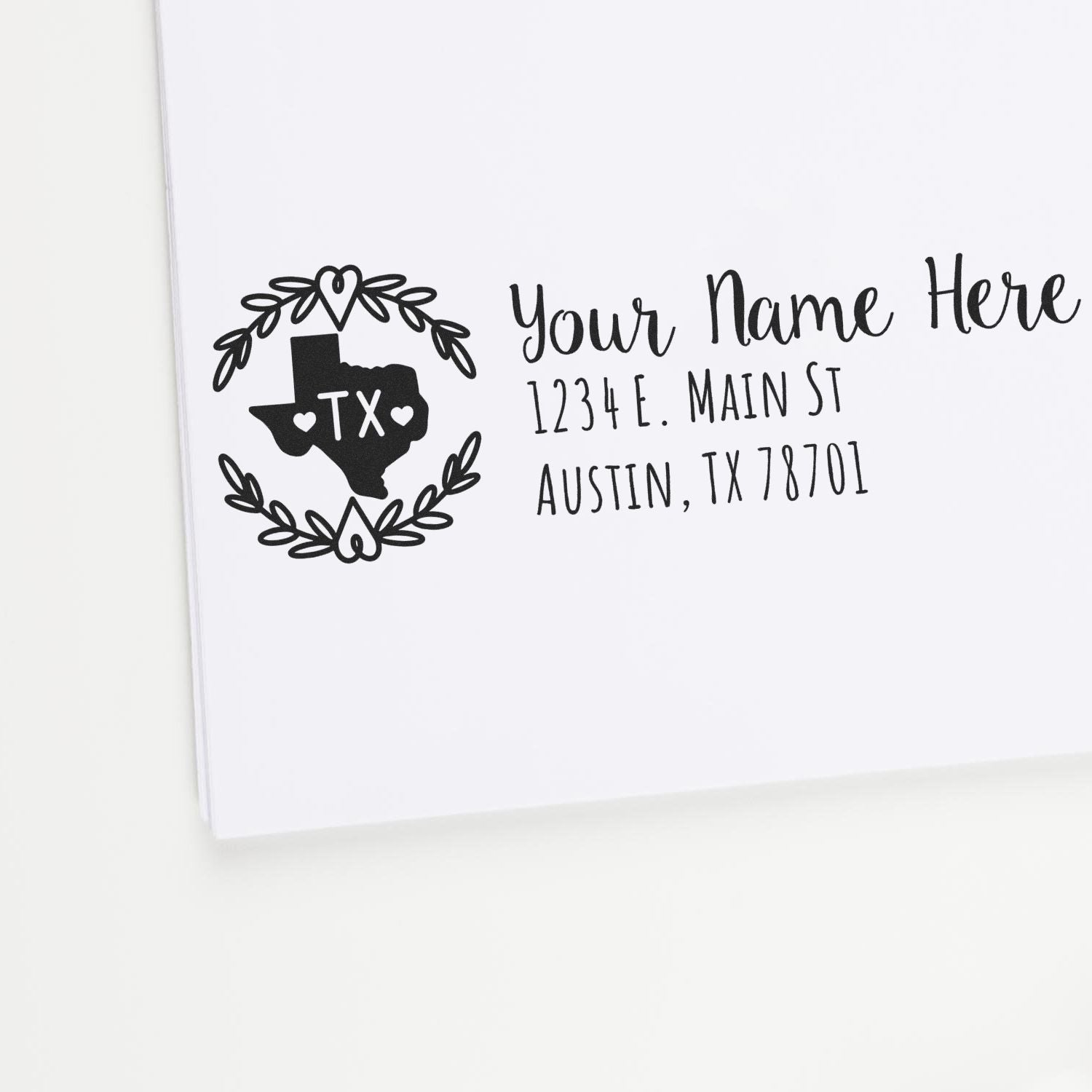 PSI Pre-Inked Texas State Customized Address Stamp on white paper, featuring a Texas outline with hearts and floral design, alongside customizable address text in elegant font.