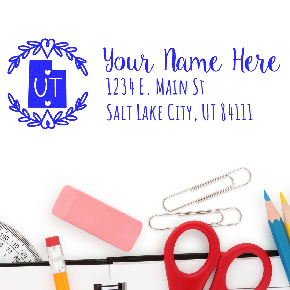 Utah State Custom Return Address Stamp with a decorative border, featuring placeholder text for name and address. Surrounded by office supplies like scissors, pencils, and an eraser.